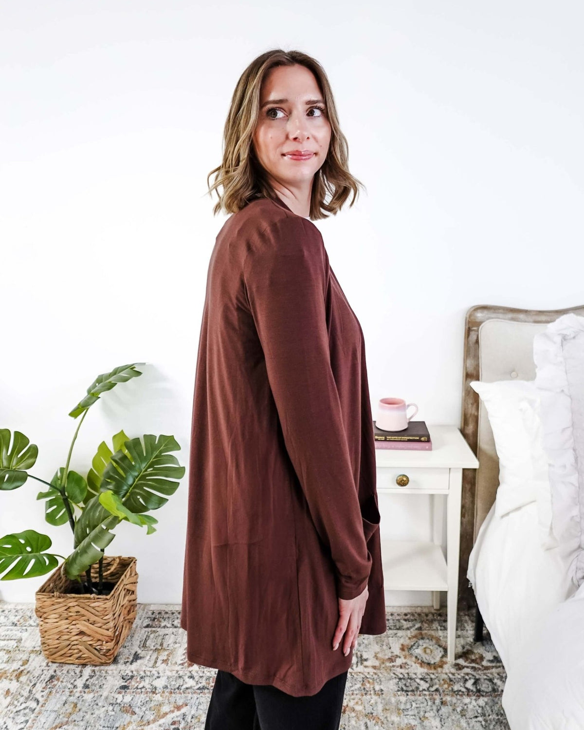 Woman wearing a brown long-sleeve cardigan in a bedroom setting Scarlett Ellie Summer Open Lightweight Cardigan | Cloud Nine Pajamas
