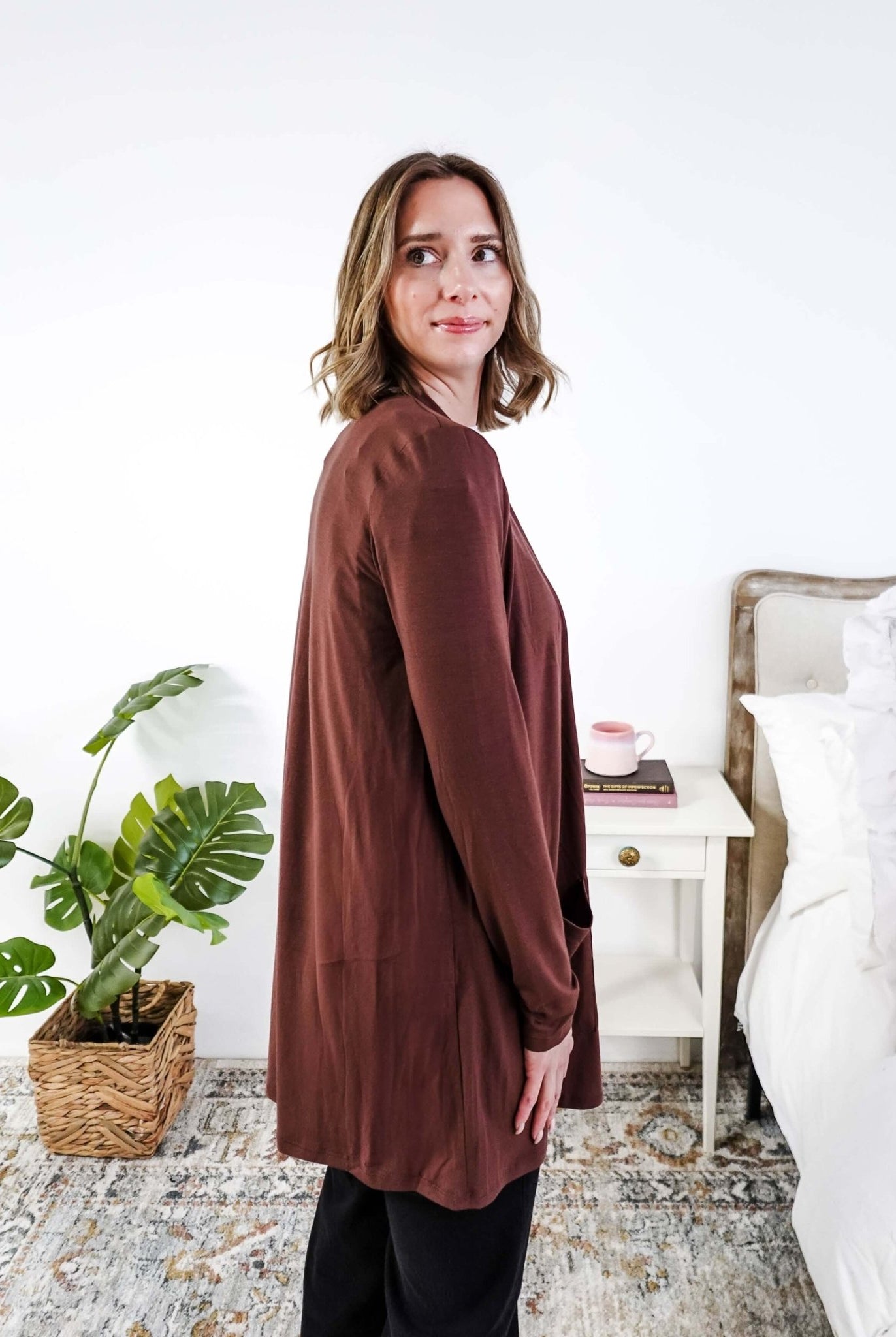 Woman wearing a brown long-sleeve cardigan in a bedroom setting Scarlett Ellie Summer Open Lightweight Cardigan | Cloud Nine Pajamas