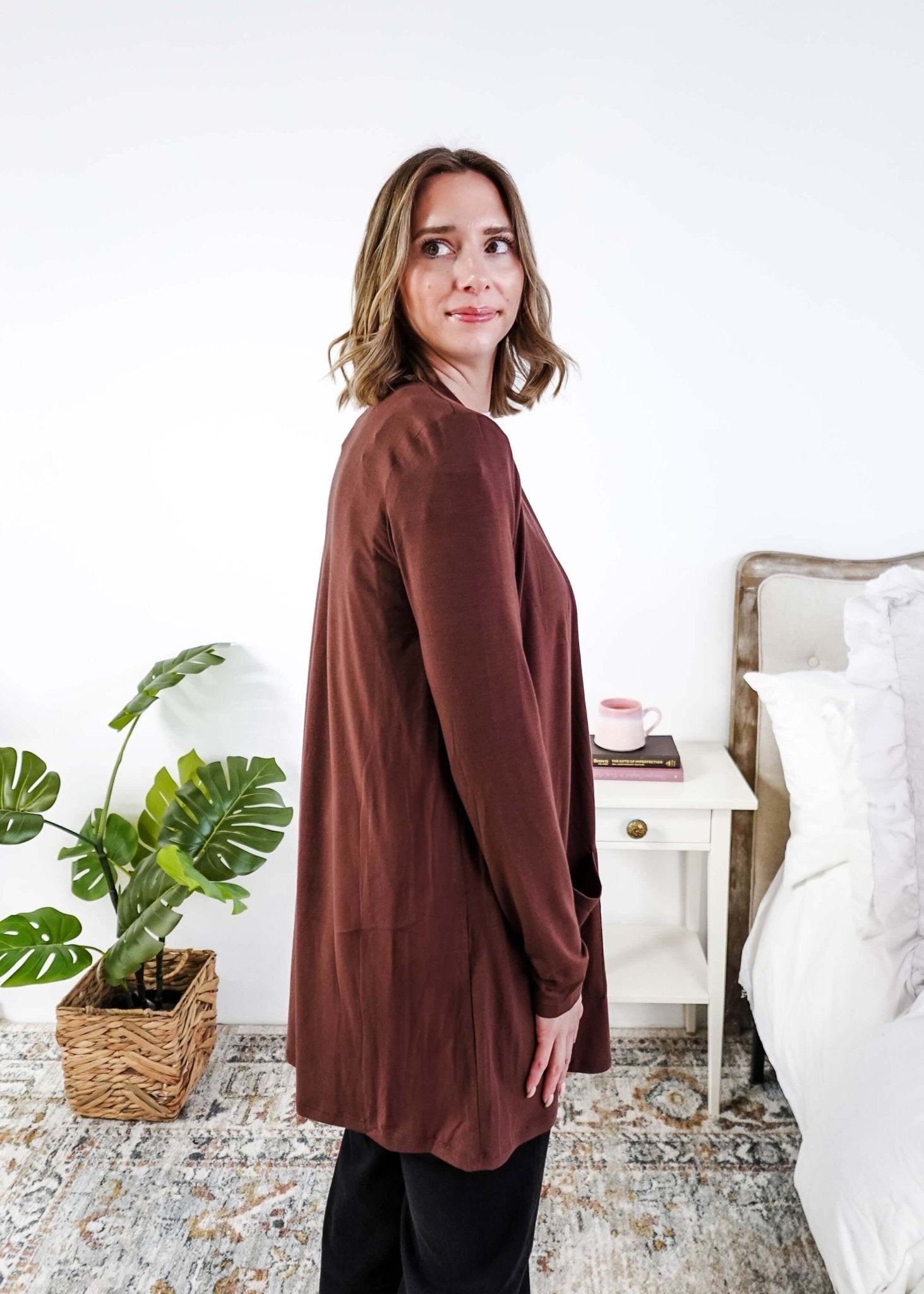 Woman wearing a brown long-sleeve cardigan in a bedroom setting Scarlett Ellie Summer Open Lightweight Cardigan | Cloud Nine Pajamas