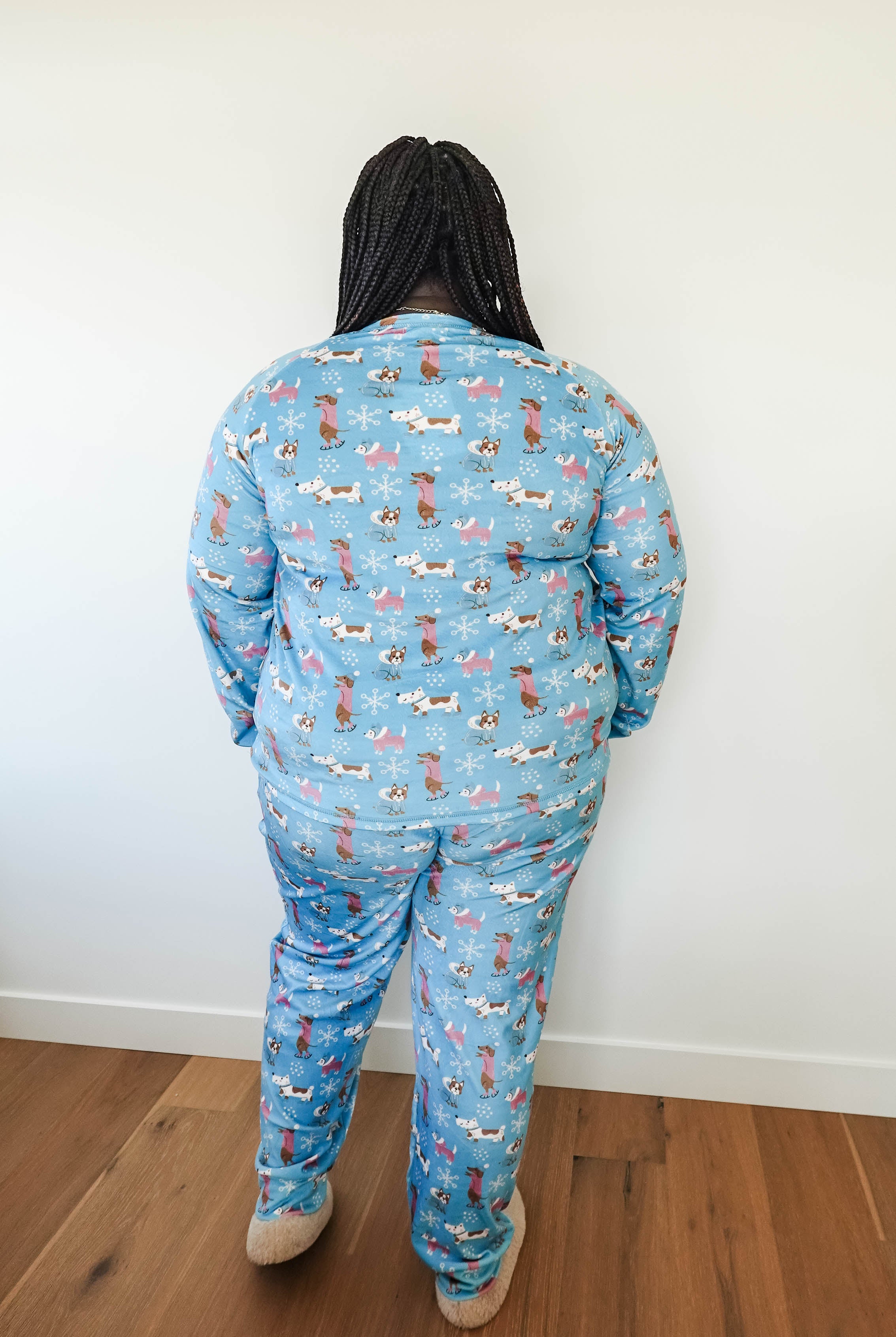 Back view of a person wearing the Paws On Ice Long Sleeve Jogger Velour Lounge Set by Miranda Nic, featuring whimsical winter patterns.