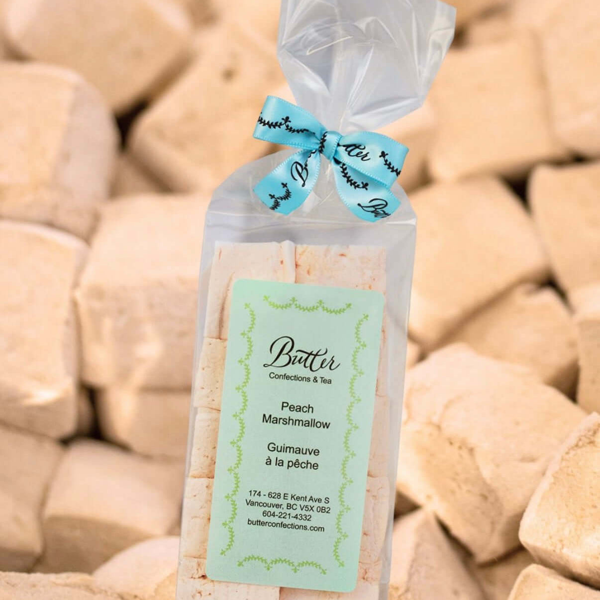 Handcrafted Gourmet Marshmallows in a clear bag with peach flavor and decorative ribbon, perfect for indulging.