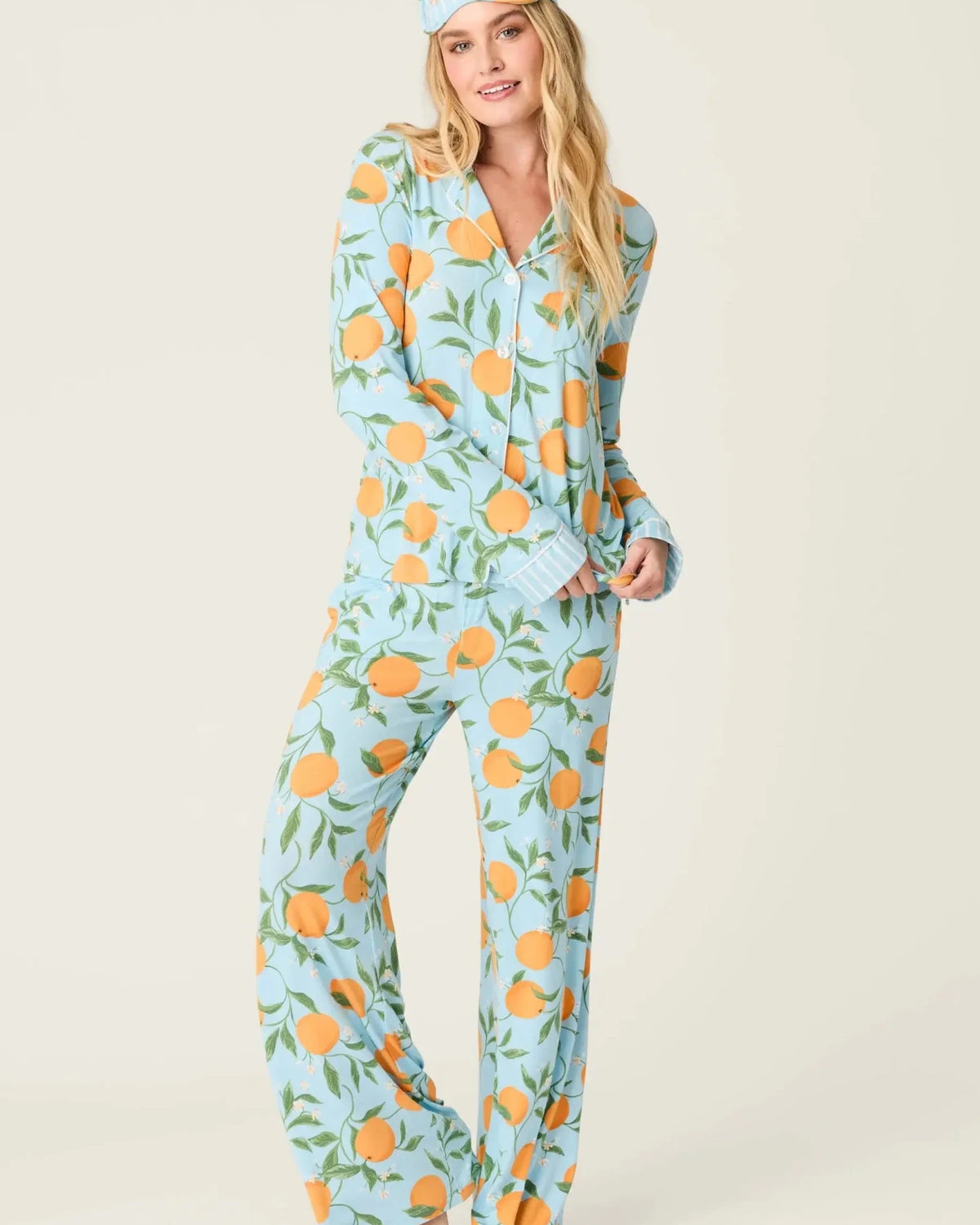 Model wearing PJ Salvage Citrus Dreams 3-Piece PJ Set featuring orange design with matching eye mask.