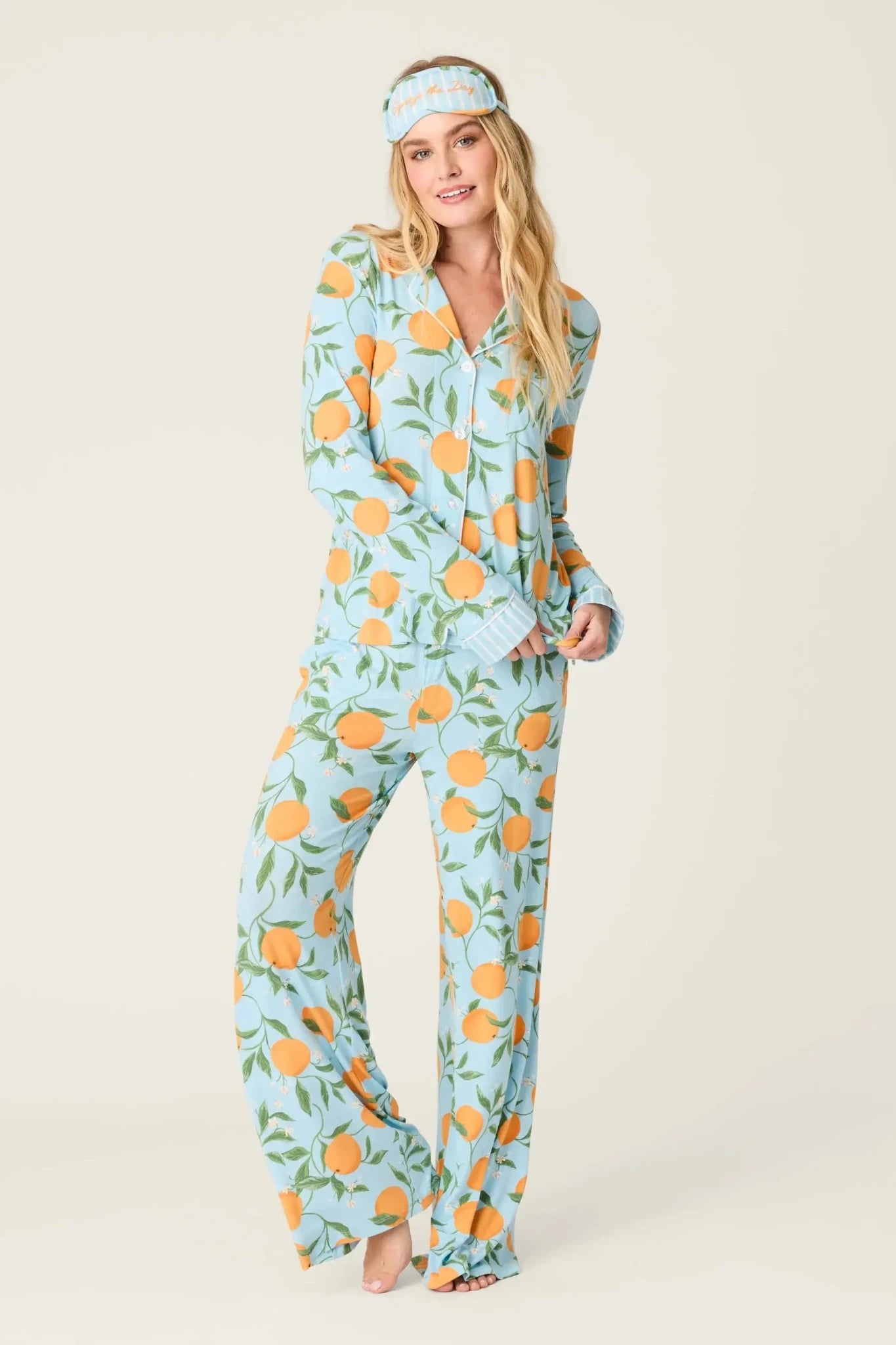 Model wearing PJ Salvage Citrus Dreams 3-Piece PJ Set featuring orange design with matching eye mask.