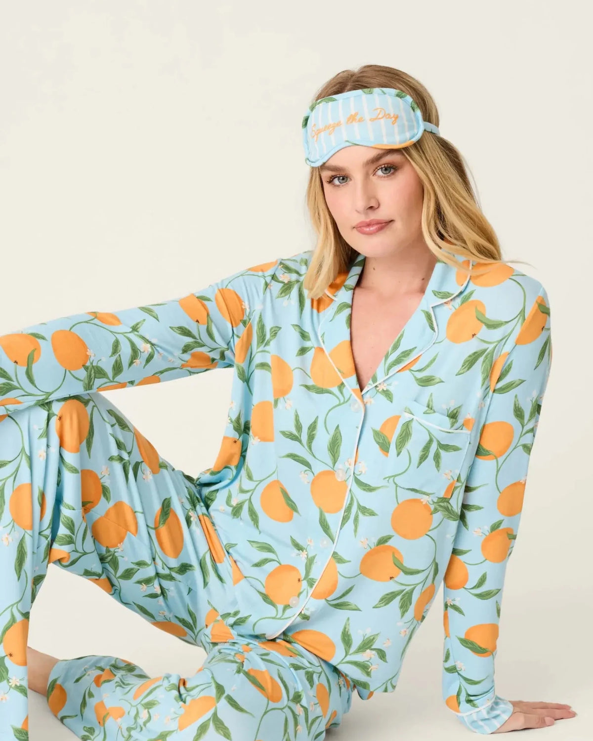 Model wearing PJ Salvage Citrus Dreams 3-Piece PJ Set featuring orange design with matching eye mask.