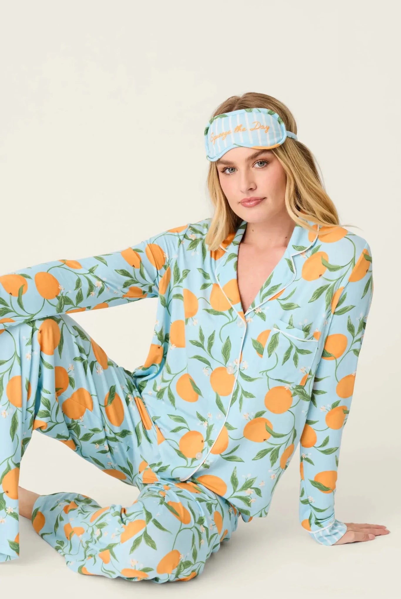 Model wearing PJ Salvage Citrus Dreams 3-Piece PJ Set featuring orange design with matching eye mask.