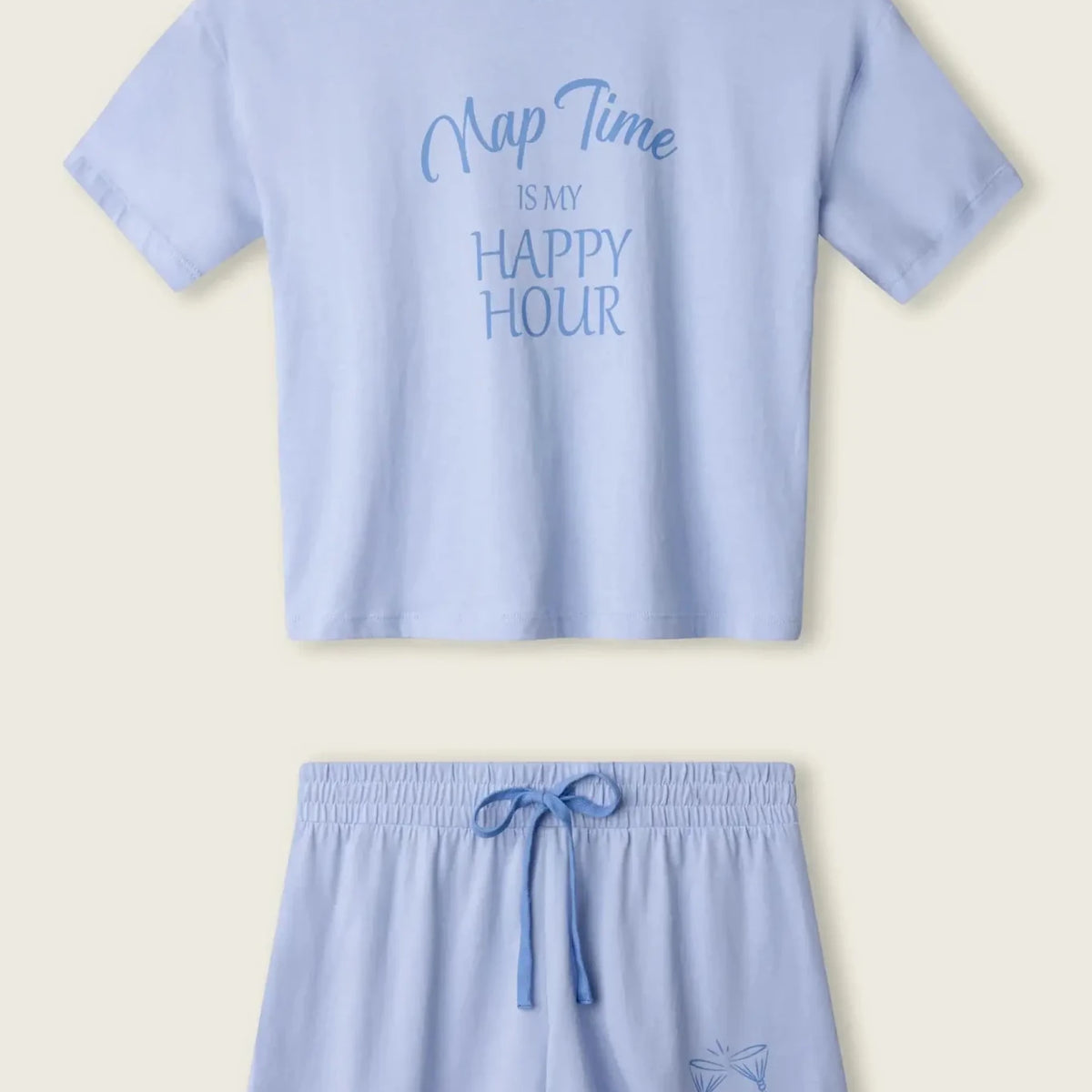 PJ SALVAGE Graphic Print Softee Tee & Short Lounge Set in "Nap Time is my Happy Hour" graphic tee shirt in light blue. Product lay flat on a light background shot