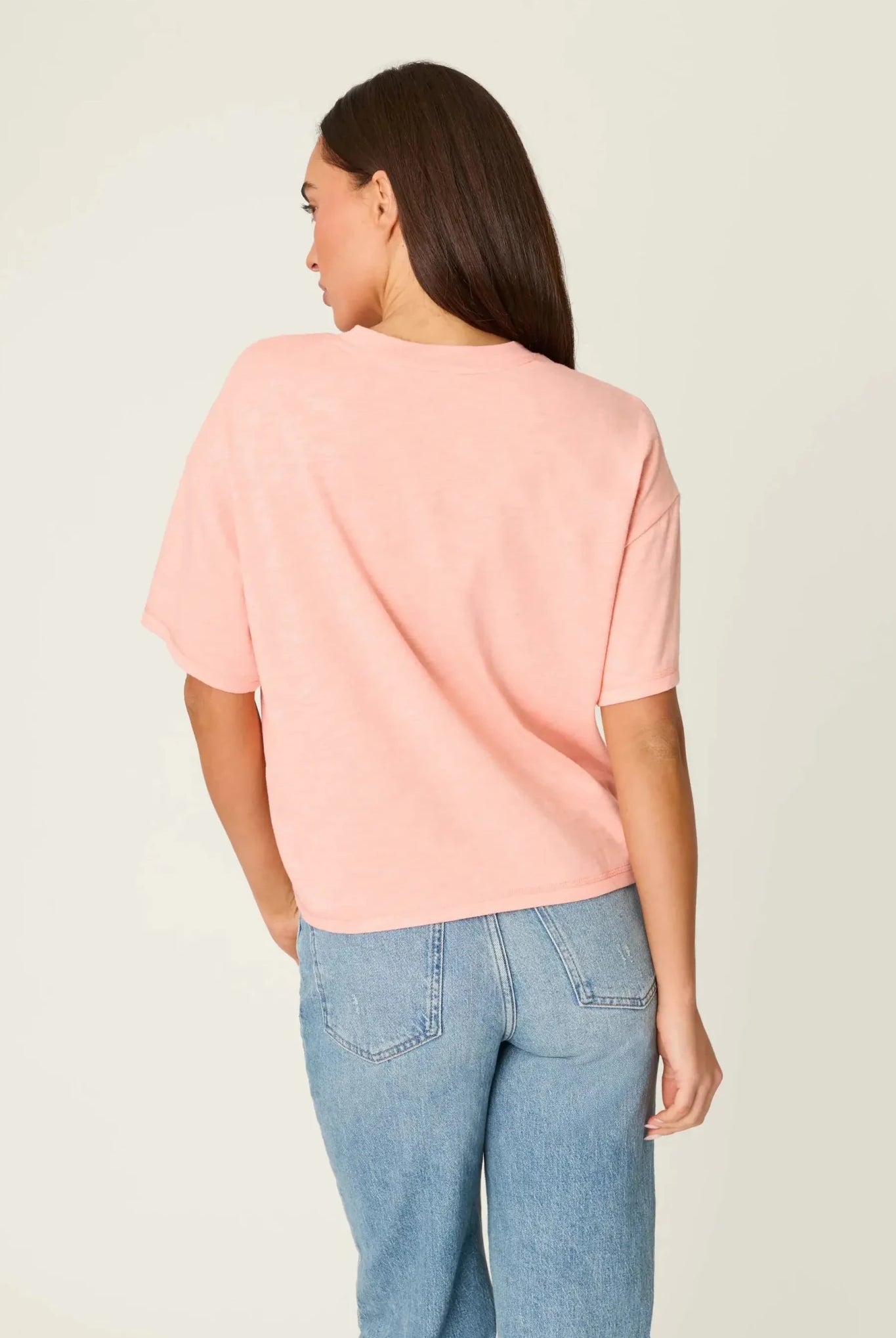 Model wearing PJ Salvage Paloma Mama "Tequila Por Favor" Graphic Tee in light pink with a cocktail graphic. back view of model