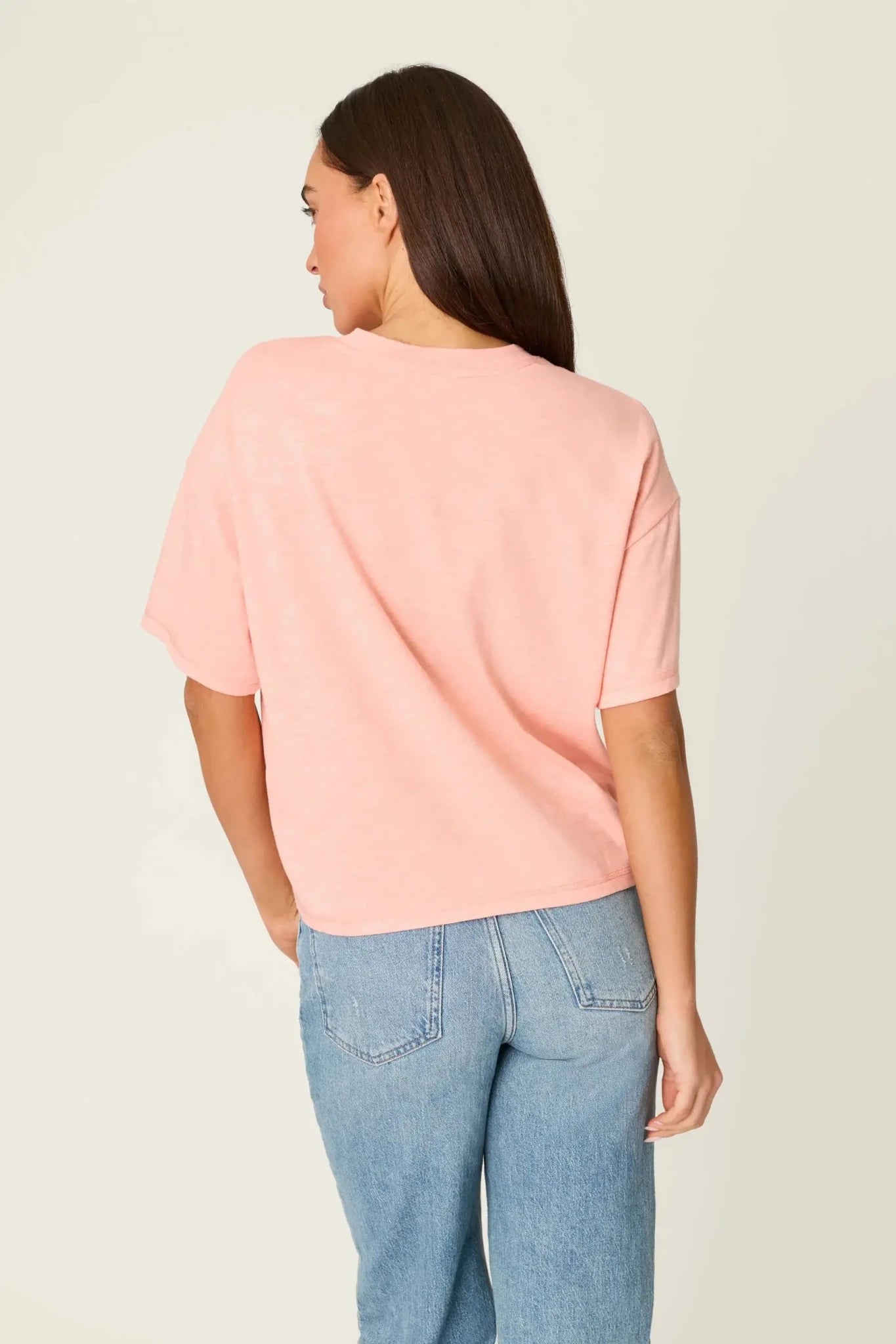 Model wearing PJ Salvage Paloma Mama "Tequila Por Favor" Graphic Tee in light pink with a cocktail graphic. back view of model