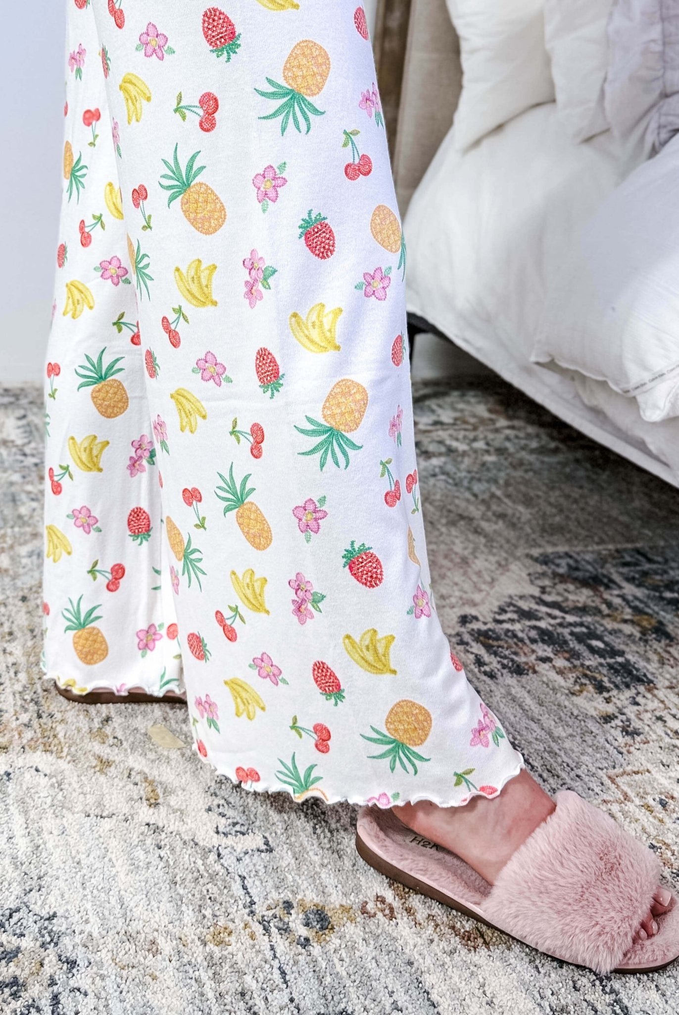 PJ SALVAGE — Viva la Vida Fruit Fiesta Long Sleeve & Pant Set worn on model in a bedroom setting, showing lettuce scalloped detail of the hem of the straight leg pant