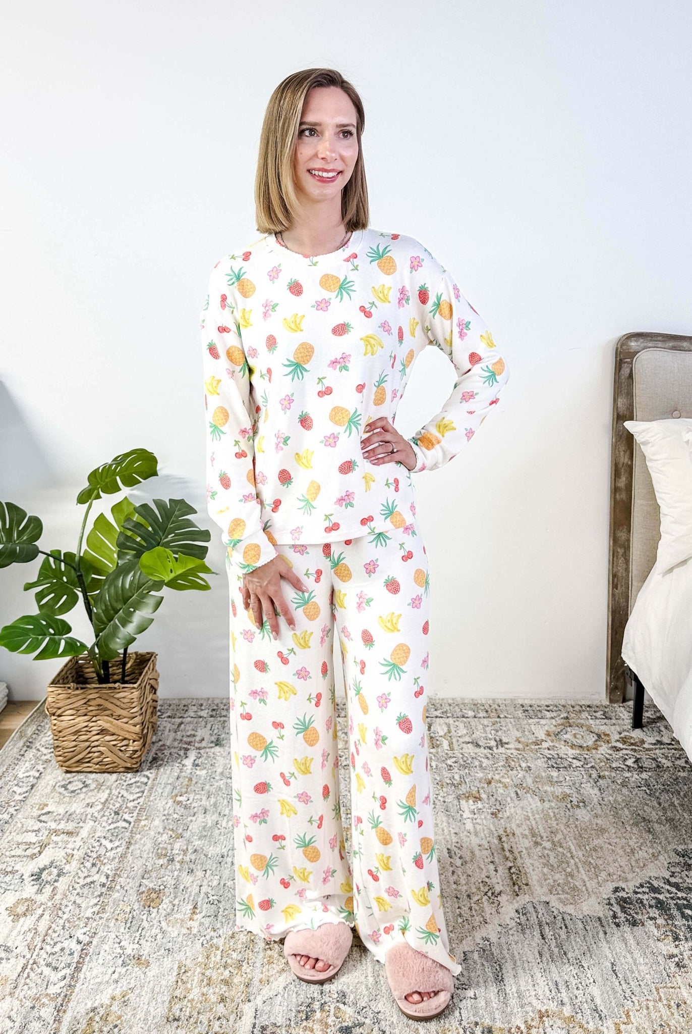 PJ SALVAGE — Viva la Vida Fruit Fiesta Long Sleeve & Pant Set worn on model in a bedroom setting, showing full length of the fruit print pj set