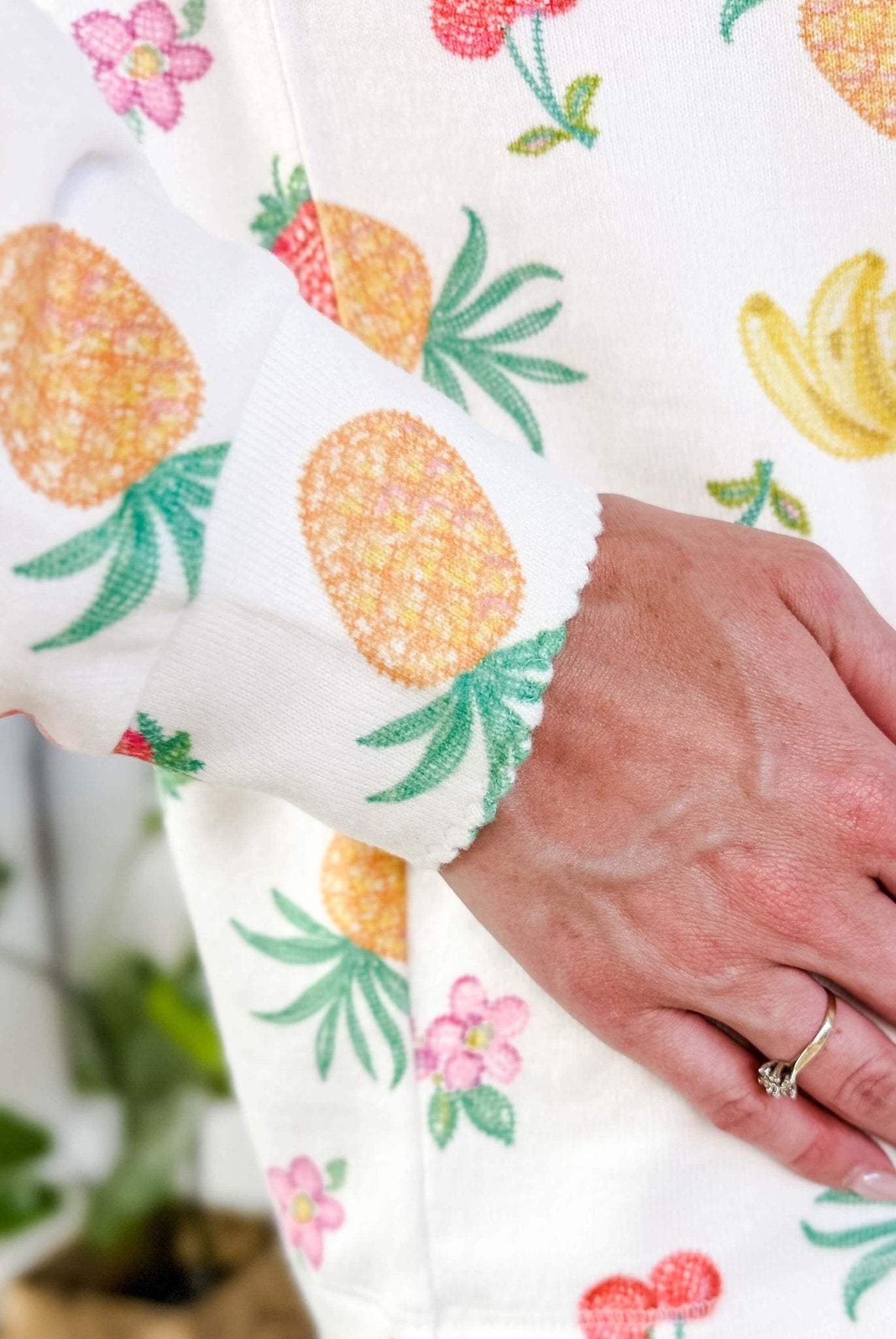 PJ SALVAGE — Viva la Vida Fruit Fiesta Long Sleeve & Pant Set worn on model in a bedroom setting, close up of scalloped detail on cuff of the long sleeve top