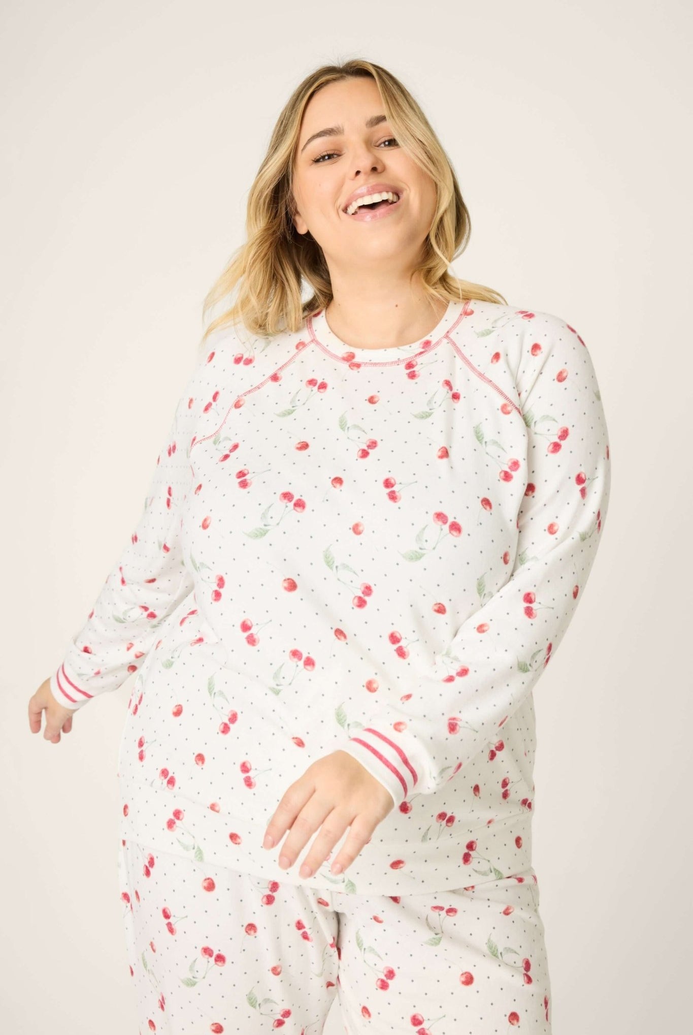 Polka Dot Cherries Peachy Jersey Pajama Set PJ Salvage model wearing pajama set with cherry and polka dot pattern.