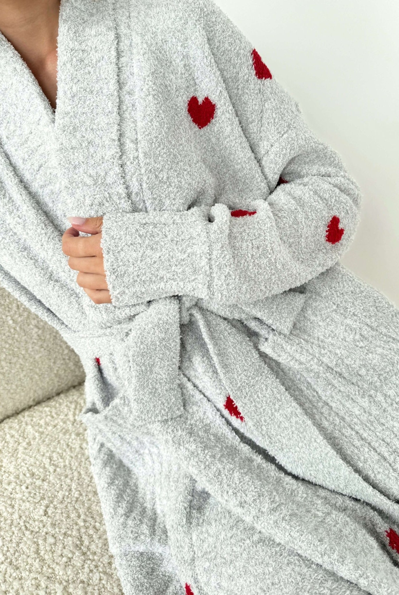 Model wearing the Pomona Fuzzy Yarn Robe Splendid in gray with red hearts, close up of print