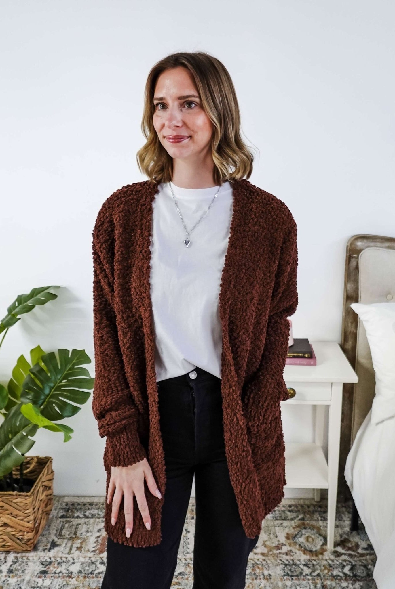 Woman wearing a brown cardigan with texture in a bedroom setting, Popcorn Texture Open Summer Cardigan in a chocolate brown