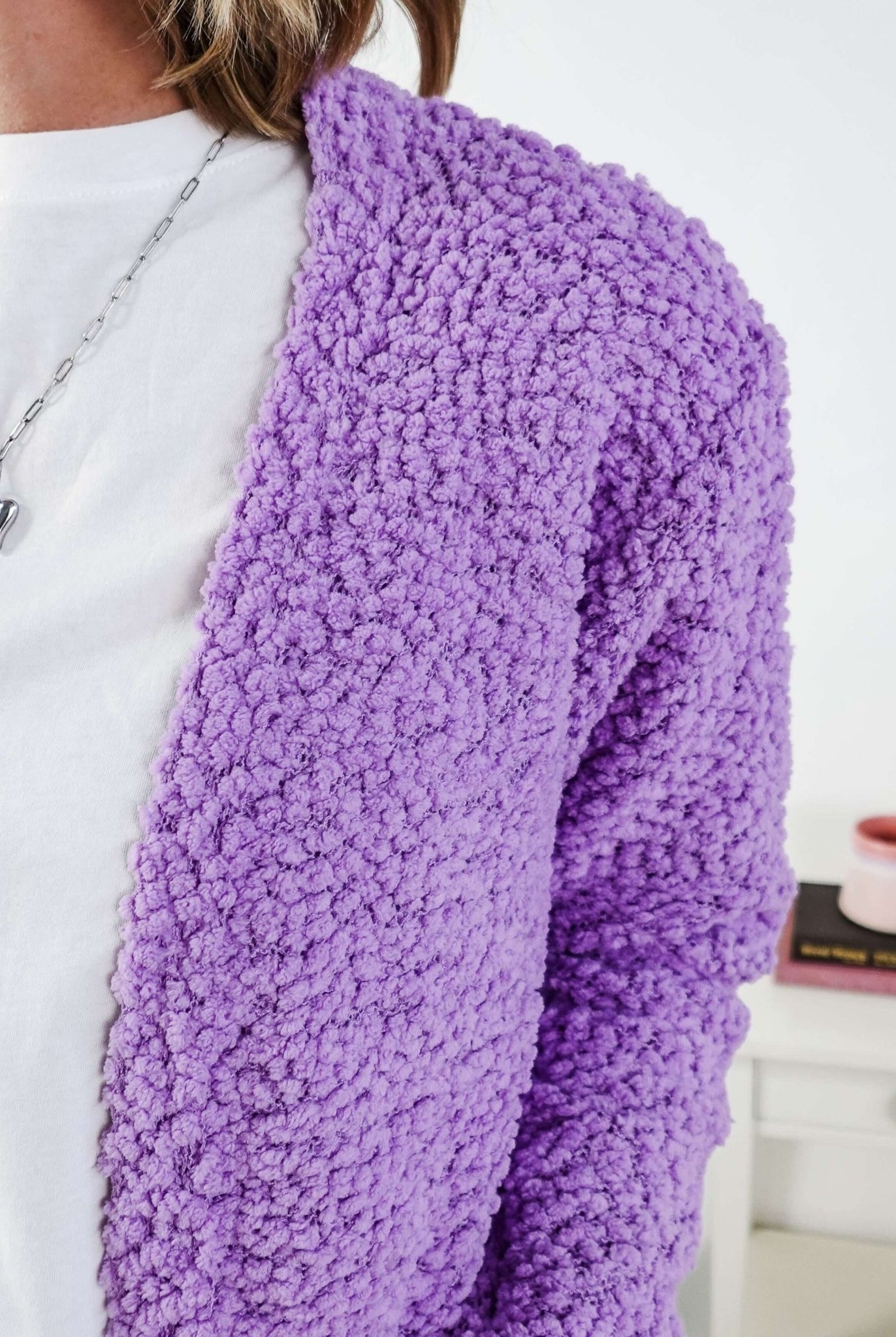 Popcorn Texture Open Summer Cardigan Woman wearing a light purple cardigan with texture in a bedroom setting, showing texture of the fluffy knit
