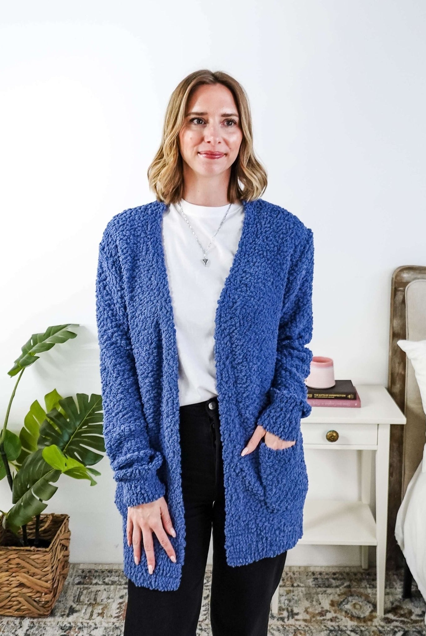 Woman wearing a blue cardigan with texture in a bedroom setting, Popcorn Texture Open Summer Cardigan in a lake blue