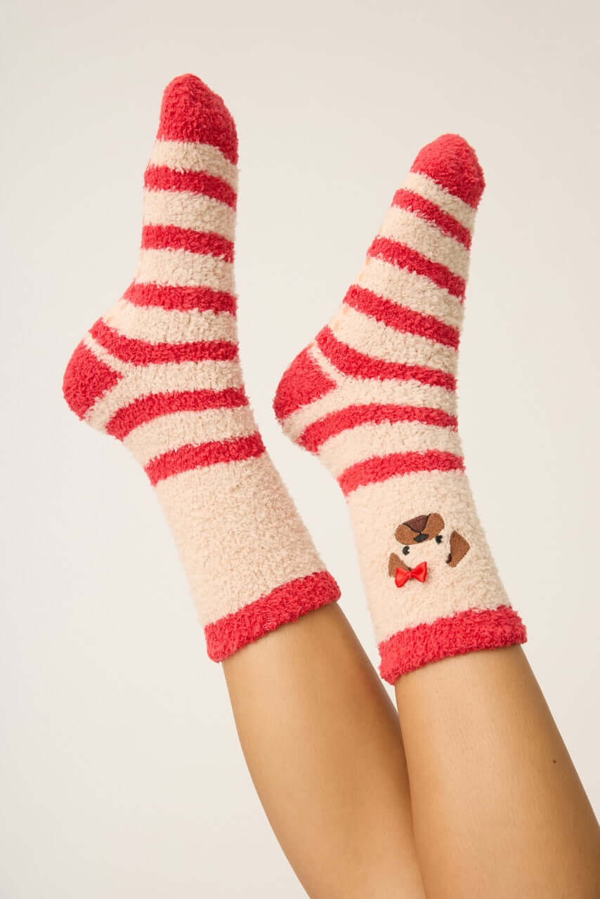 Pair of PJ Salvage Red & Tan Stripe Fuzzy Cozy Socks with the adorable pug embroidered with a bow detail. Anti-skid grippers visible on the bottom.