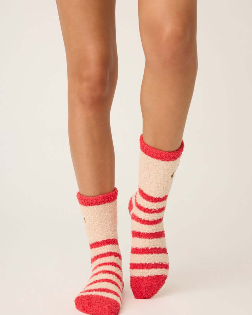 Pair of PJ Salvage Red & Tan Stripe Fuzzy Cozy Socks with the adorable pug embroidered with a bow detail. Anti-skid grippers visible on the bottom.