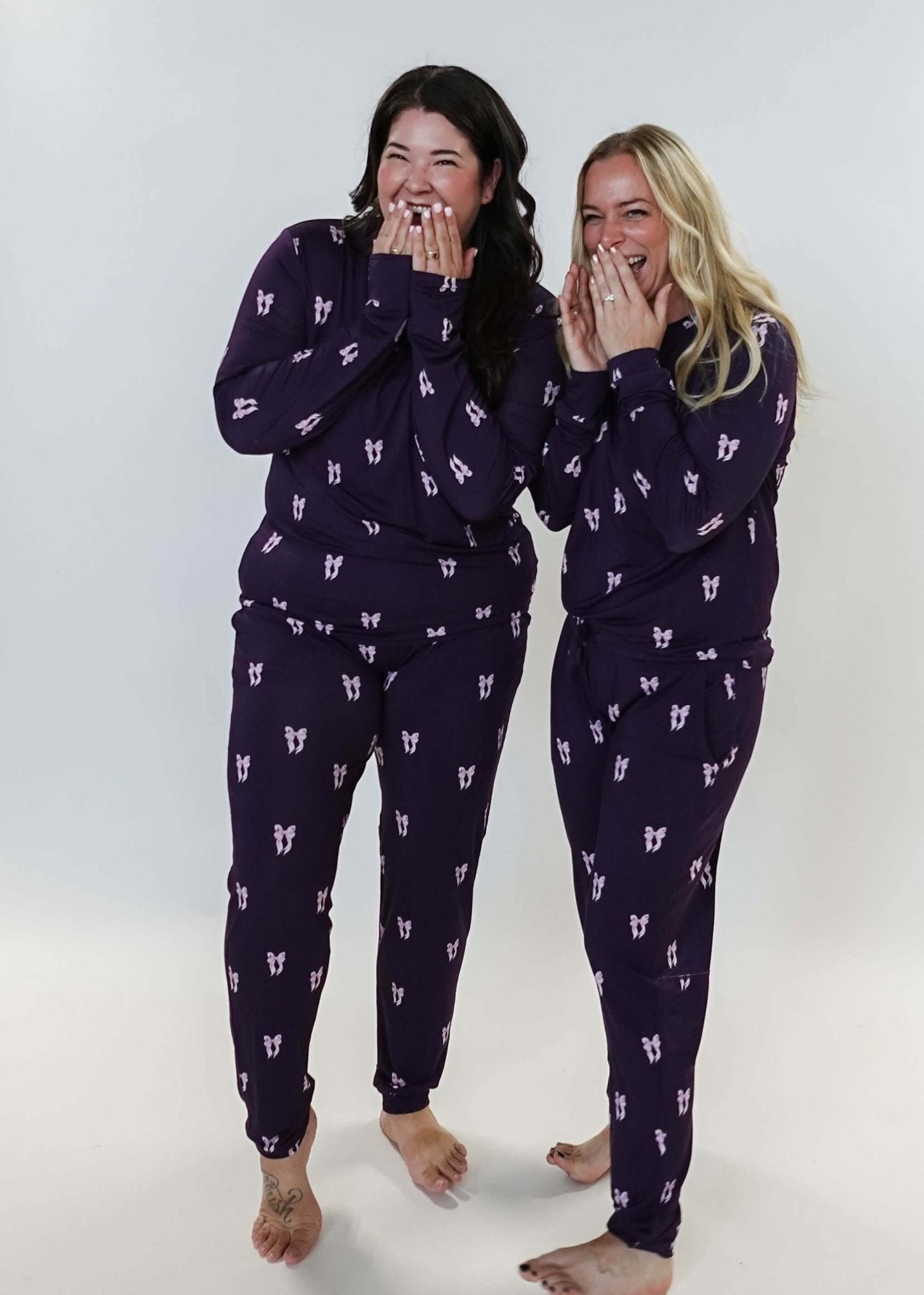 Purple Bows Print Long Sleeve & Jogger Bamboo PJ Set - two models wearing the set and sharing a giggle
