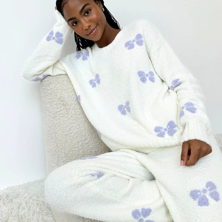 Model wearing Splendid Cloud-Soft Fuzzy Sweater Pajama Set, featuring soft fabric and purple butterfly pattern.