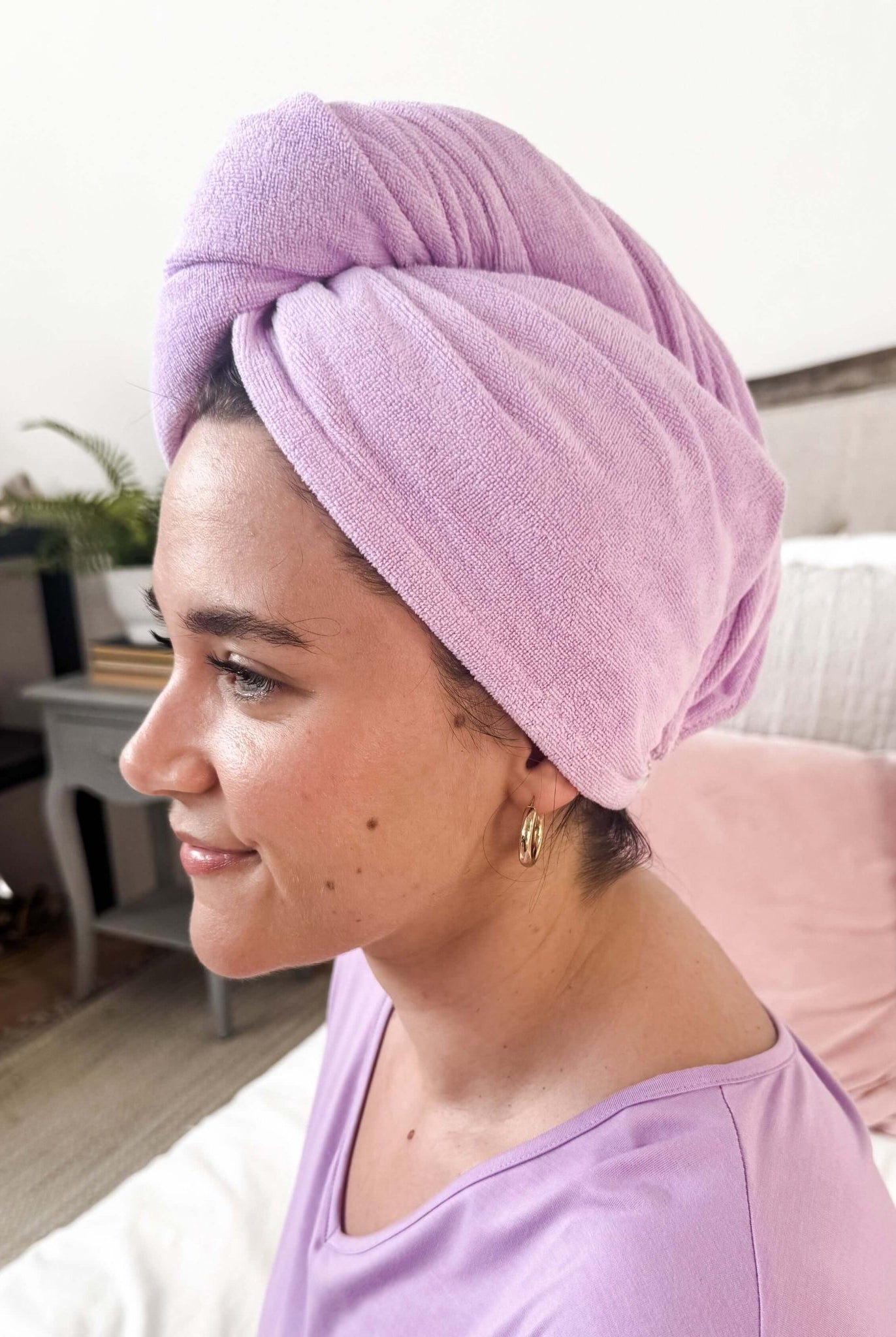 Woman wearing the Remove It Quick Dry Microfiber Hair Towel Wrap in lavender, showcasing efficient hair drying.