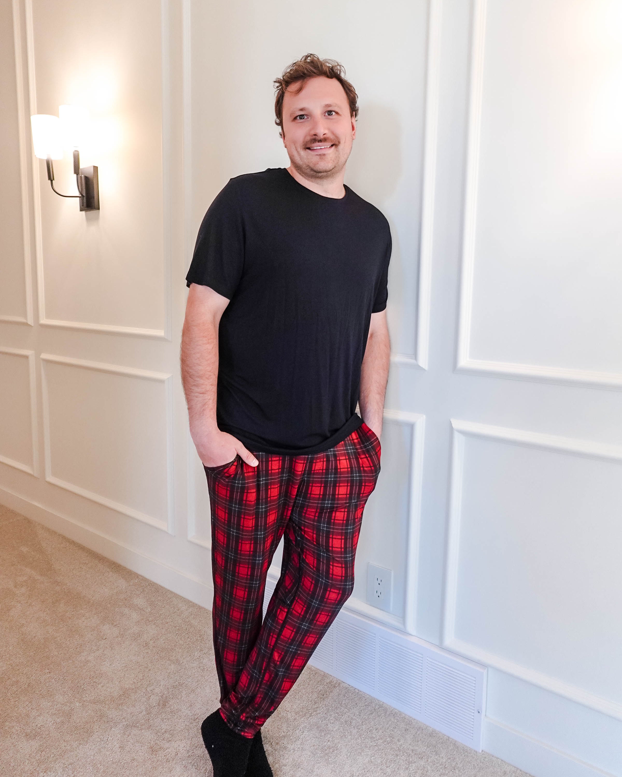 unisex joggers for men and women holiday red plaid print in soft bamboo fabric. Man wearing with black classic tee shirt