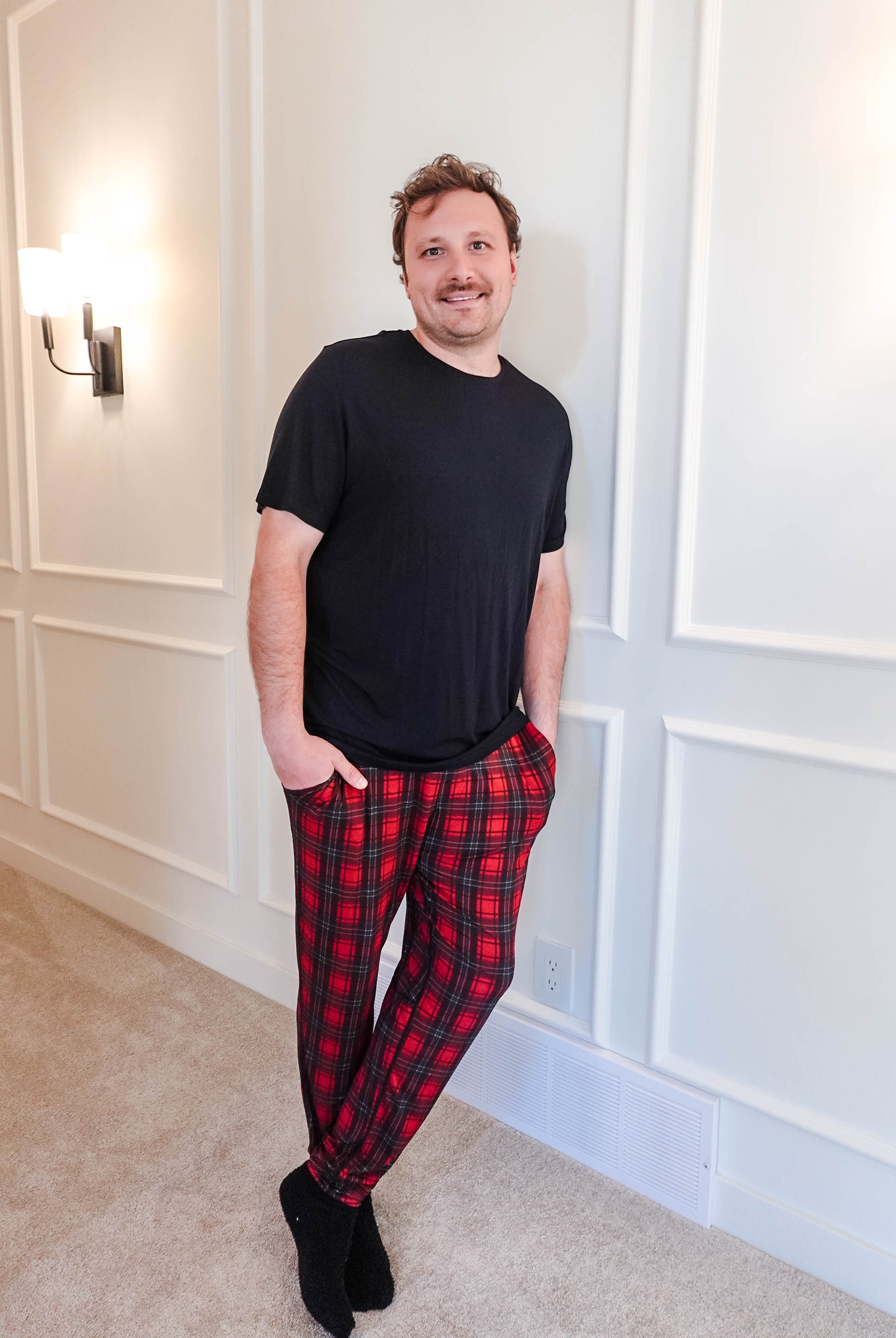 unisex joggers for men and women holiday red plaid print in soft bamboo fabric. Man wearing with black classic tee shirt