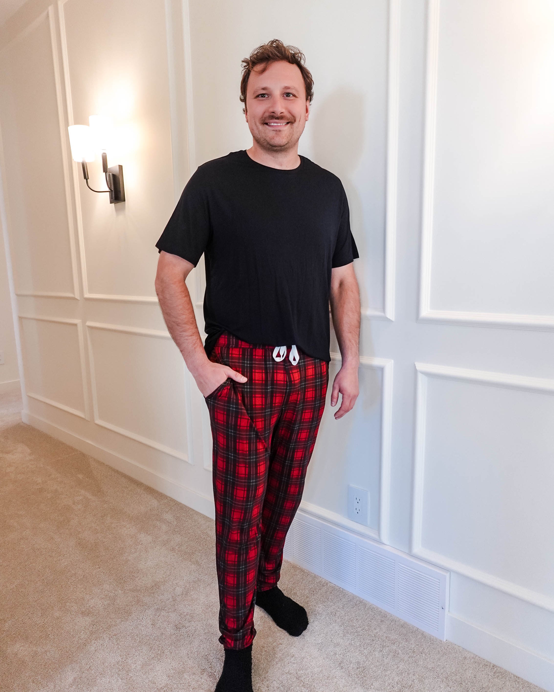 unisex joggers for men and women holiday red plaid print in soft bamboo fabric. Man wearing with classic black tee