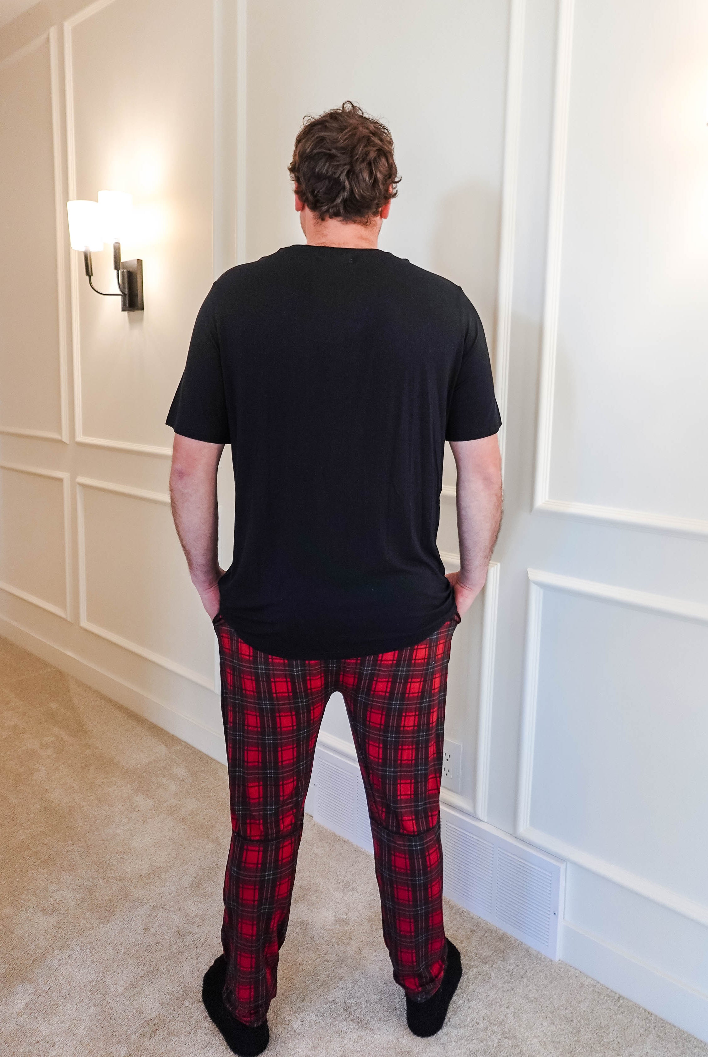 unisex joggers for men and women holiday red plaid print in soft bamboo fabric. Man wearing with classic black tee - view from back