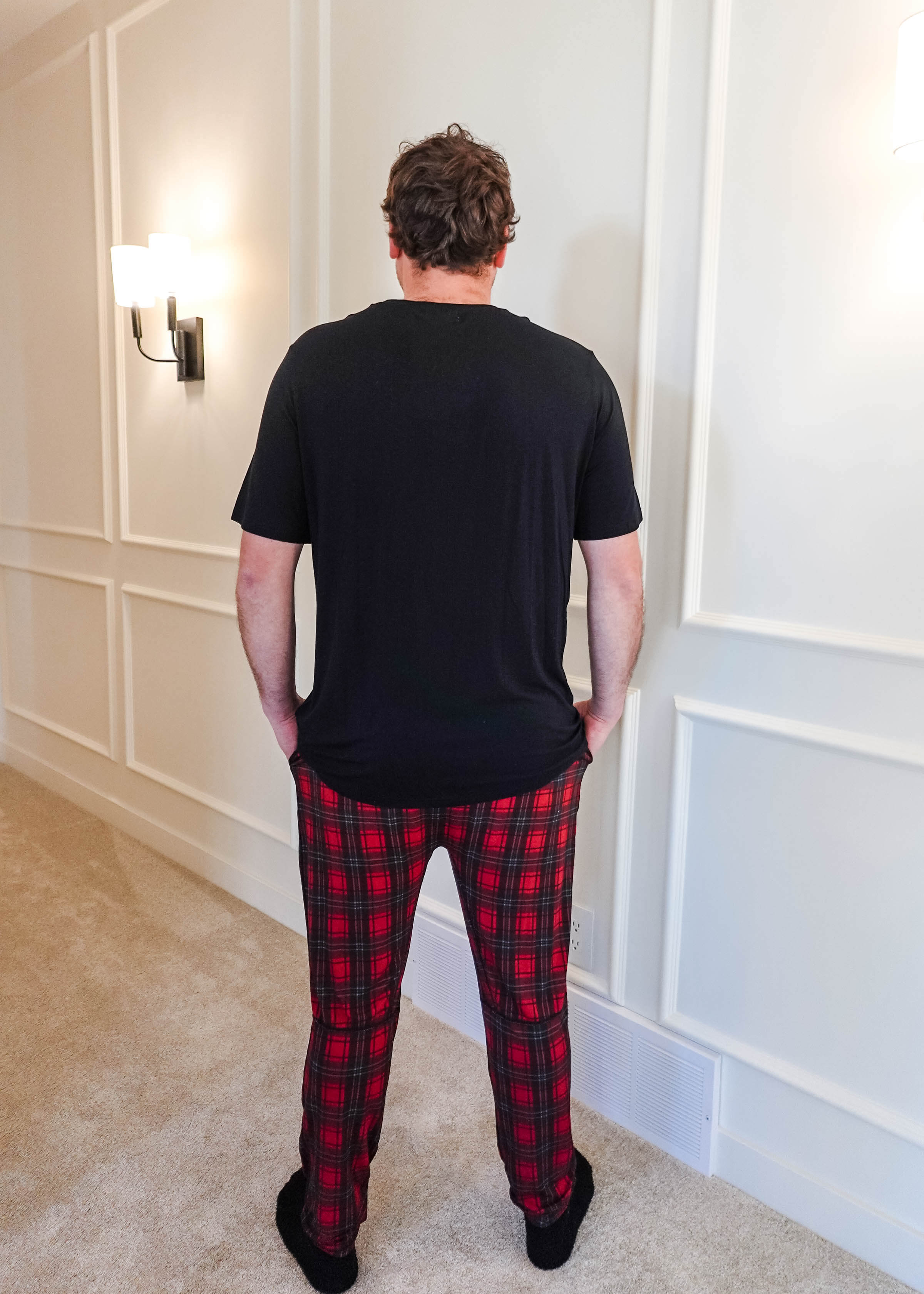 unisex joggers for men and women holiday red plaid print in soft bamboo fabric. Man wearing with classic black tee - view from back