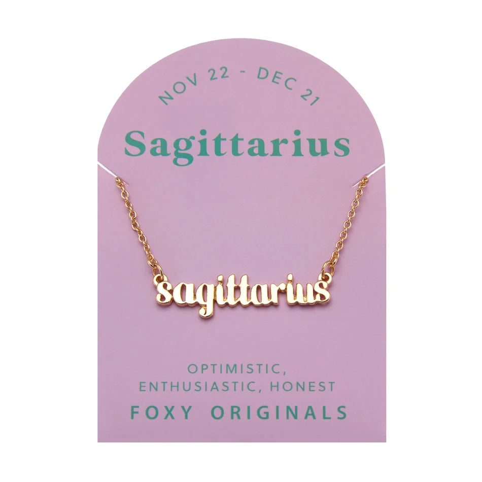 Zodiac Script Necklace in 14K Plated Gold featuring Sagittarius on a pink card, showcasing its celestial charm.