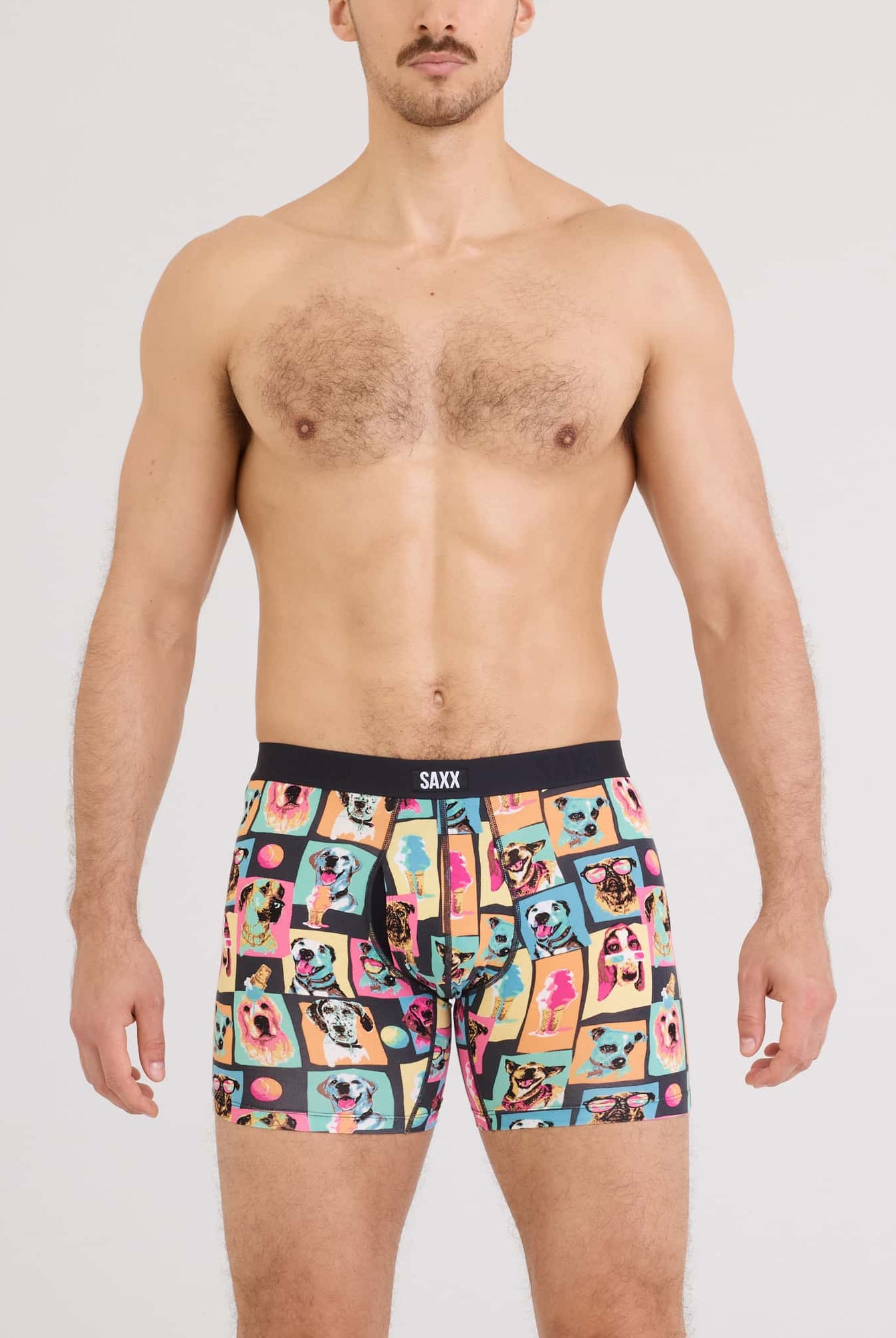 Model wearing Vibe Xtra Soft Comfort Boxer Brief in colorful fun designs by SAXX.