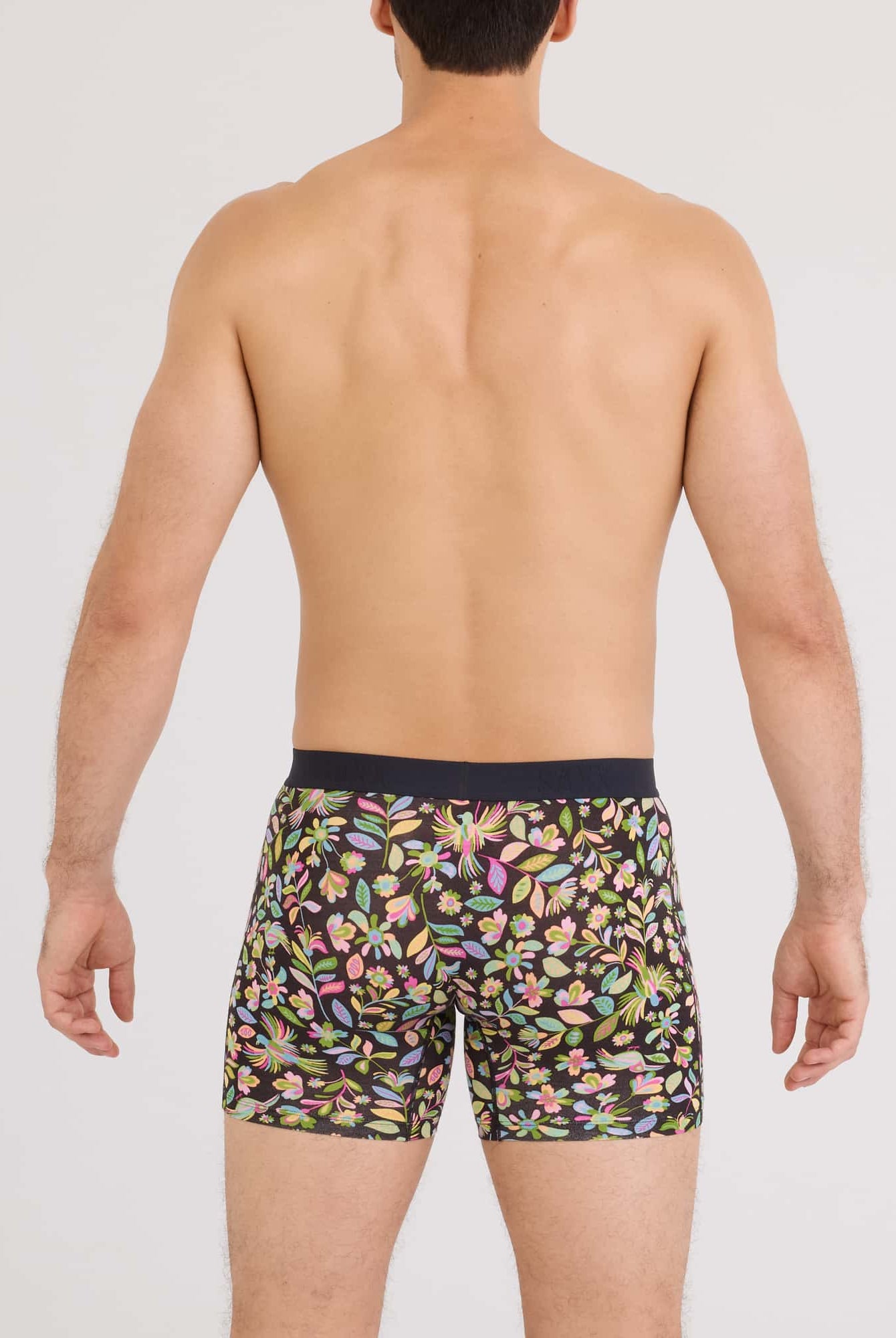 Back view of a man wearing SAXX Vibe Xtra Soft Comfort Boxer Brief in a vibrant floral print.