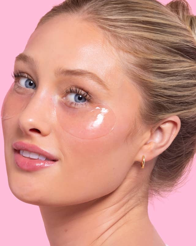 Woman with cosmetic patches under eyes on a pink background, Patchology Serve Chilled Rosé Eye Gels 5 pack antioxidant hydrating