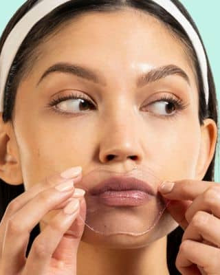 Woman applying Served Chilled Rosé Lips Gels hydrogel mask for moisturized and soft lips.