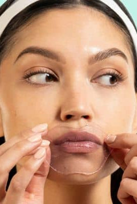Woman applying Served Chilled Rosé Lips Gels hydrogel mask for moisturized and soft lips.
