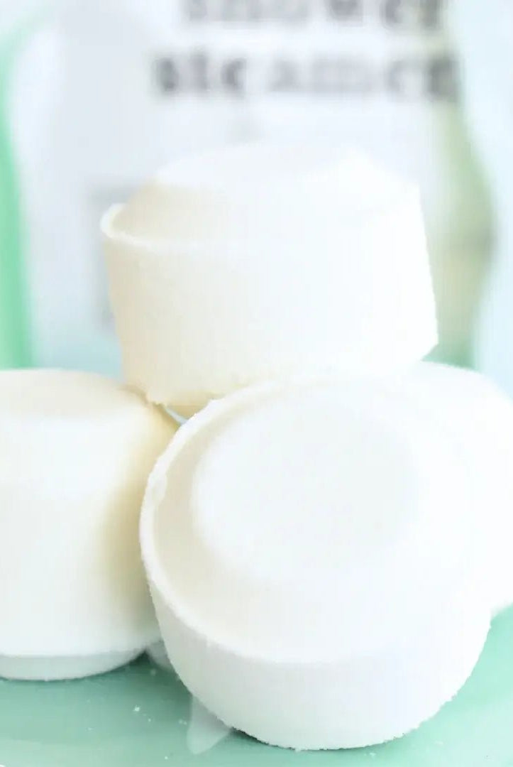 Shower Steamer 2pk Eucalyptus Mint products displayed on a light green plate, creating a soothing spa vibe.