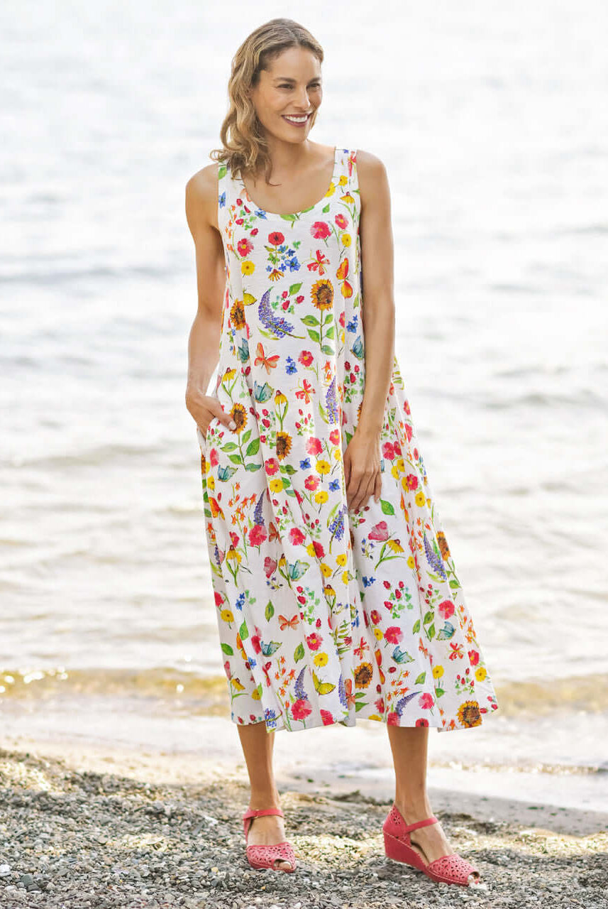 April Cornell Sister Garden Cotton Midi Floral Dress - A line style dress with pockets. Shown on a model in full length against a beach background