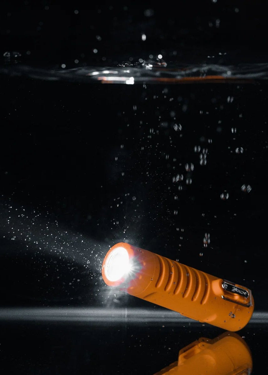 Sizzle Survival USB Rechargeable Electric Plasma Lighter & Flashlight showing flashlight on under water (shown in Orange, available in Black) - Cloud Nine Pajamas