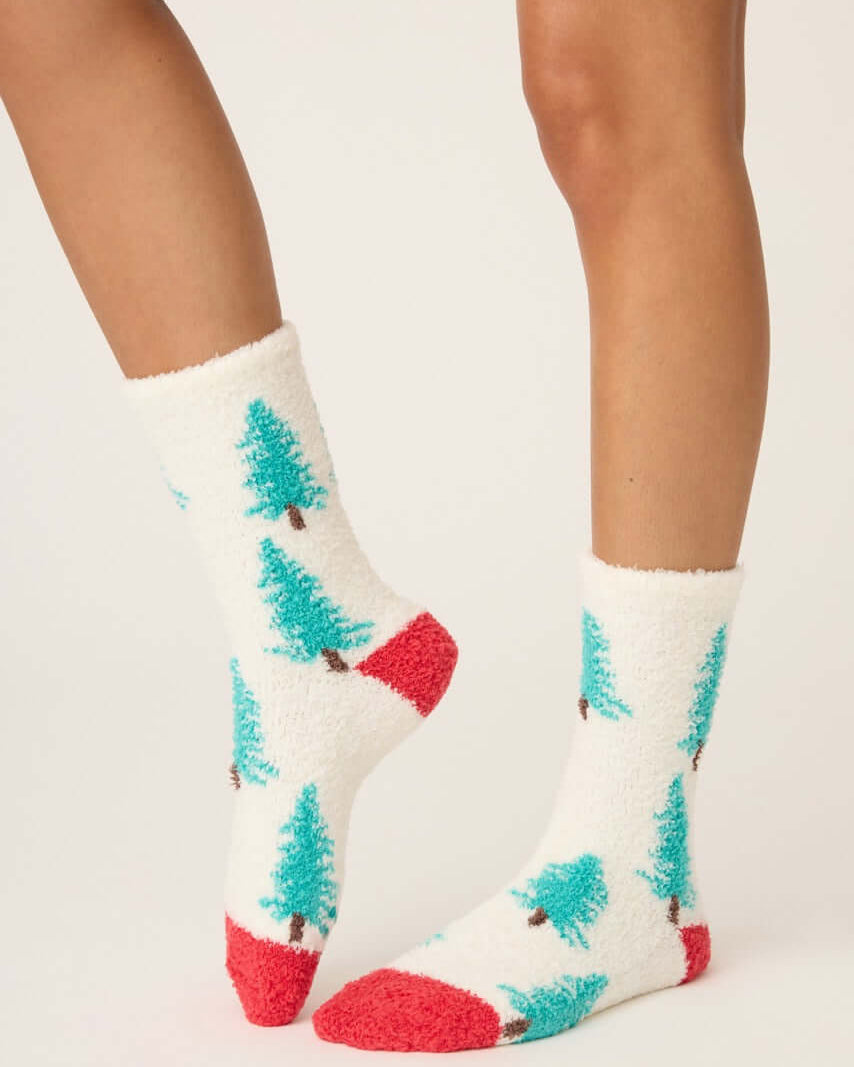 Pair of PJ Salvage "Sleigh All Day" Fuzzy Cozy Socks in ivory with green tree print and red heel