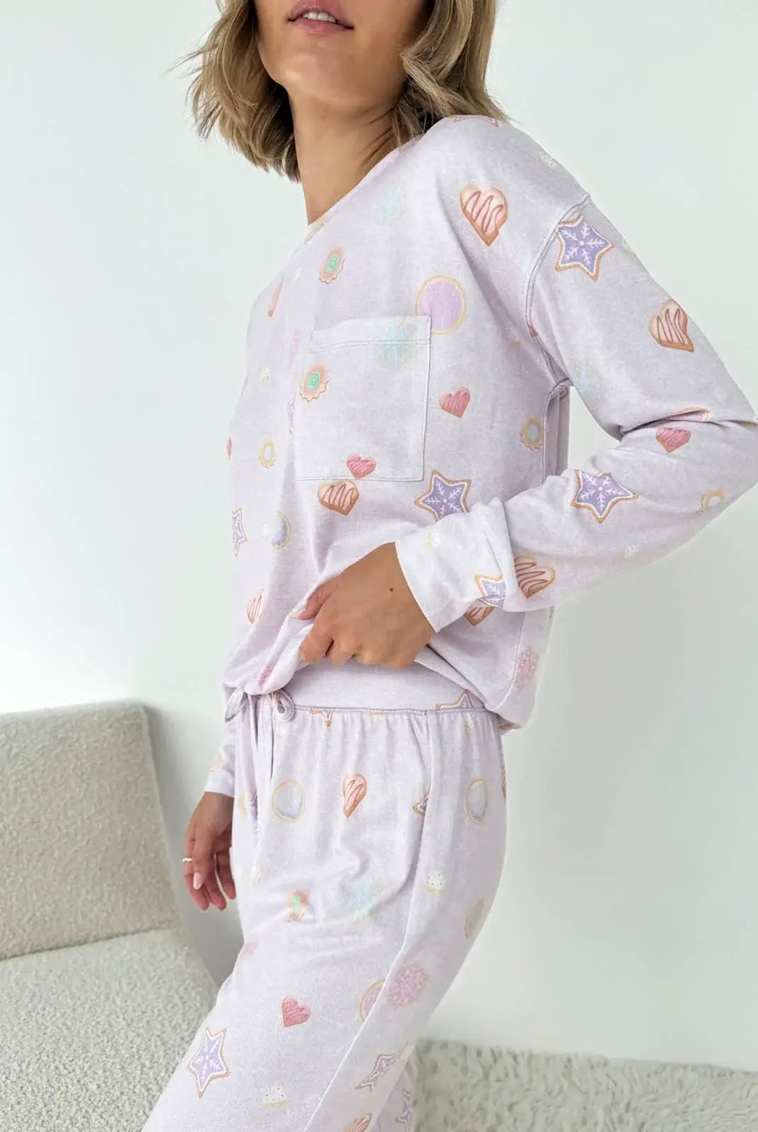 Model wearing Splendid Holiday Sugar Cookie Marna Pillowsoft PJ Set with colorful heart and star prints.