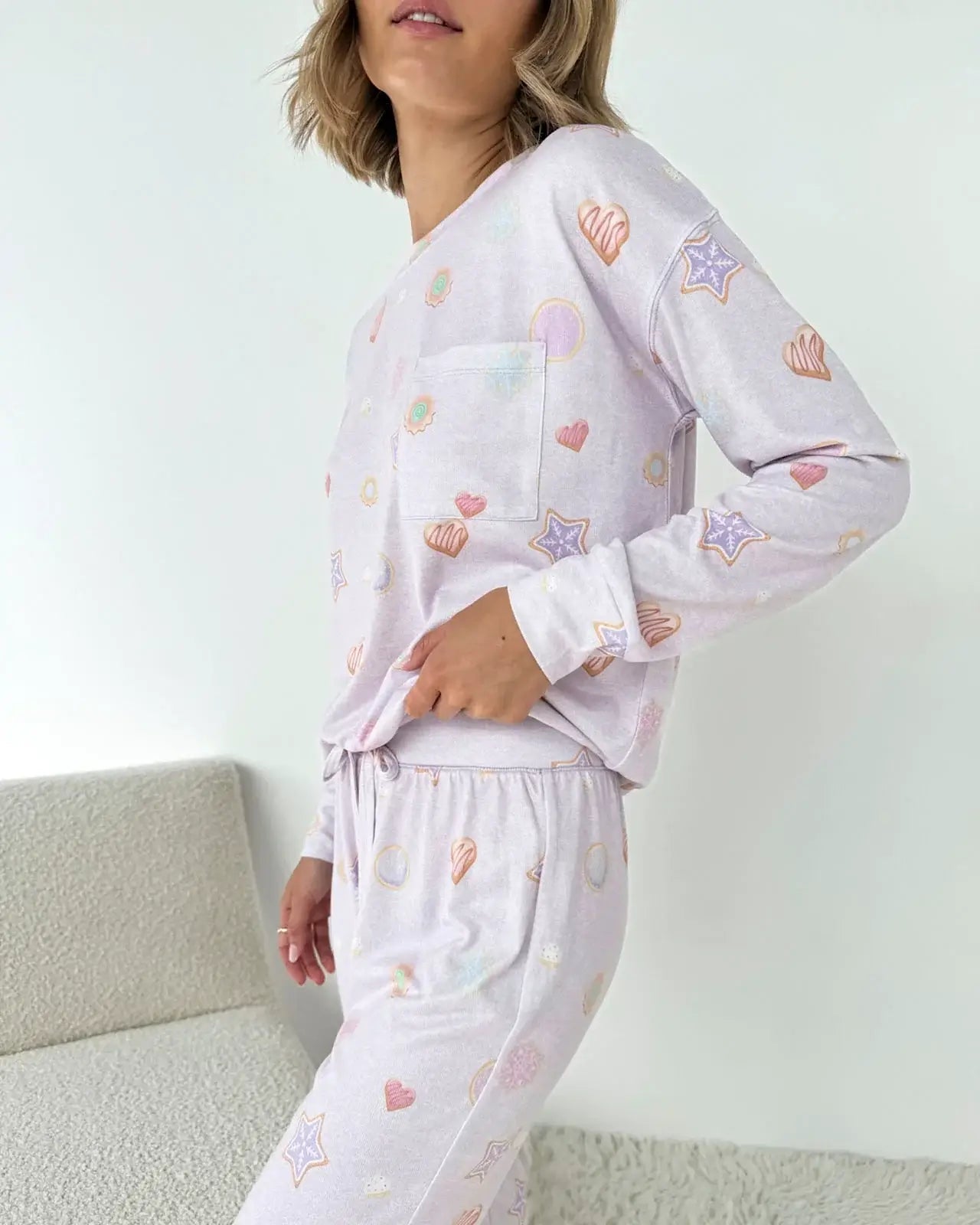 Model wearing Splendid Holiday Sugar Cookie Marna Pillowsoft PJ Set with colorful heart and star prints.