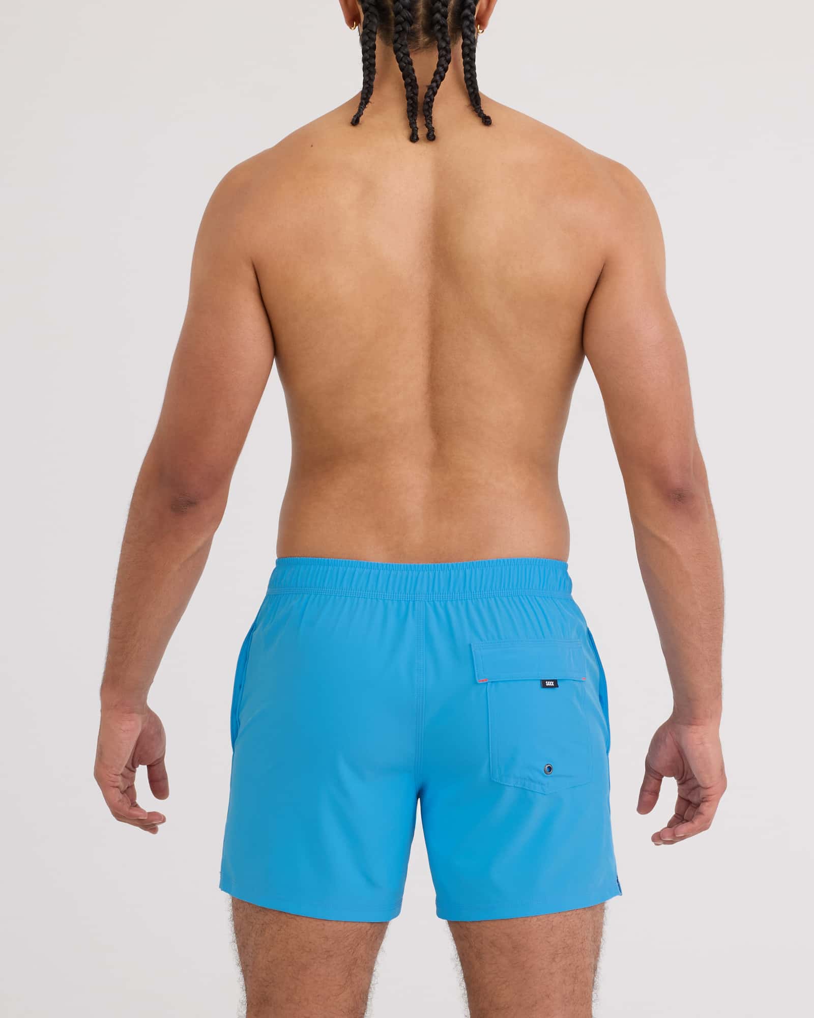 Back view of a man wearing Oh Buoy 2N1 Volley Swim Short in vibrant blue color.