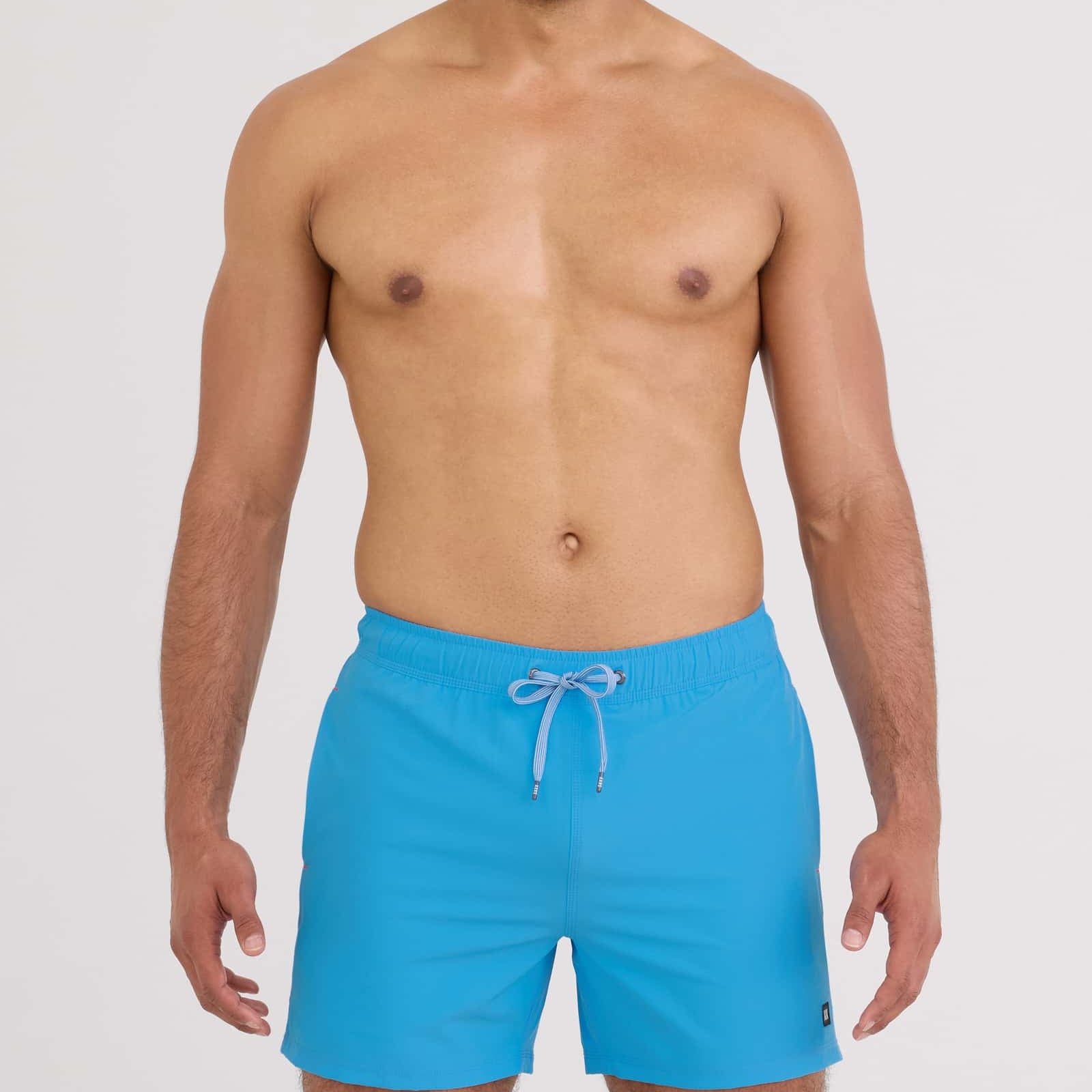 Model wearing Oh Buoy 2N1 Volley Swim Short 5" in vibrant blue color, showcasing a relaxed summer look.