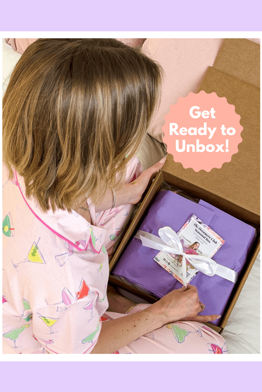 A woman in pajamas eagerly preparing to unbox The Dreamer's Club Seasonal Box - Spring Edition.