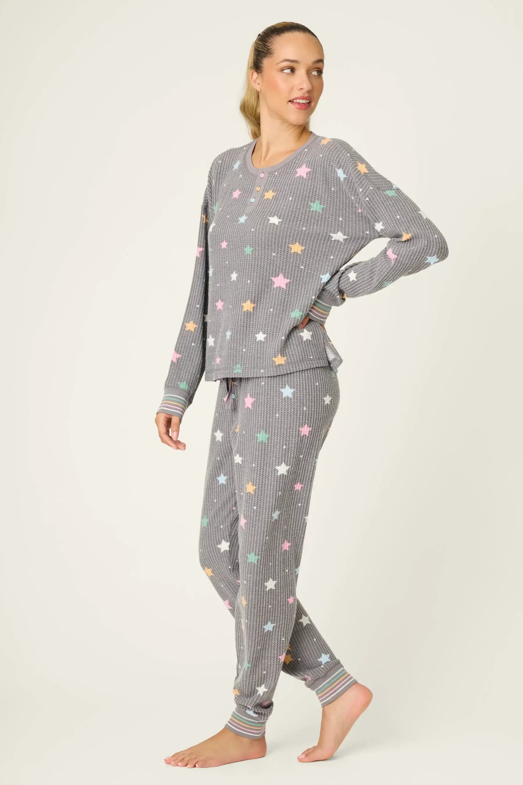 women's thermal waffle pj set with star print and charcoal grey background. Long sleeve top with buttons and Jogger bottoms by PJ Salvage