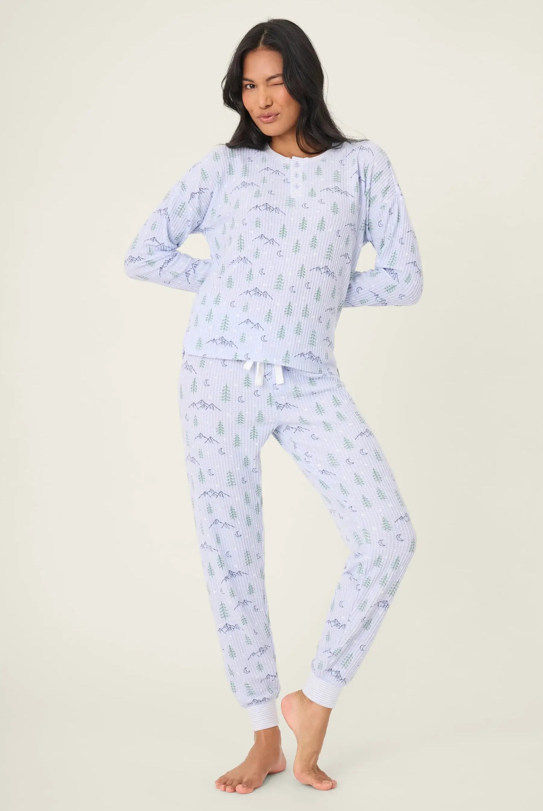 Mountain Dreams Thermal PJ Set worn by model, featuring long sleeve top and jogger bottoms with a cozy winter print.