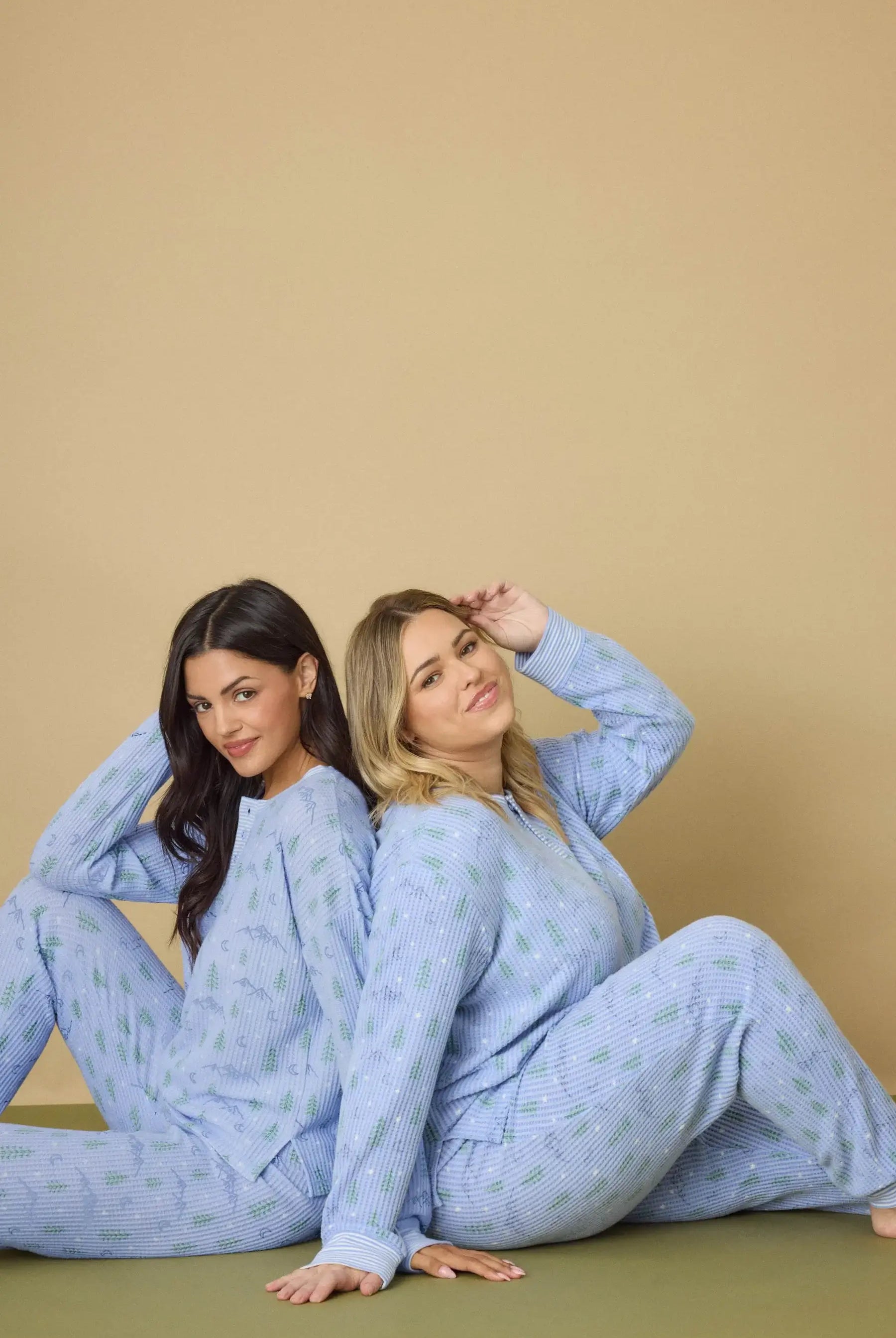 Two models wearing Mountain Dreams Thermal PJ Set by PJ Salvage, featuring long sleeves and joggers in a cozy setting.