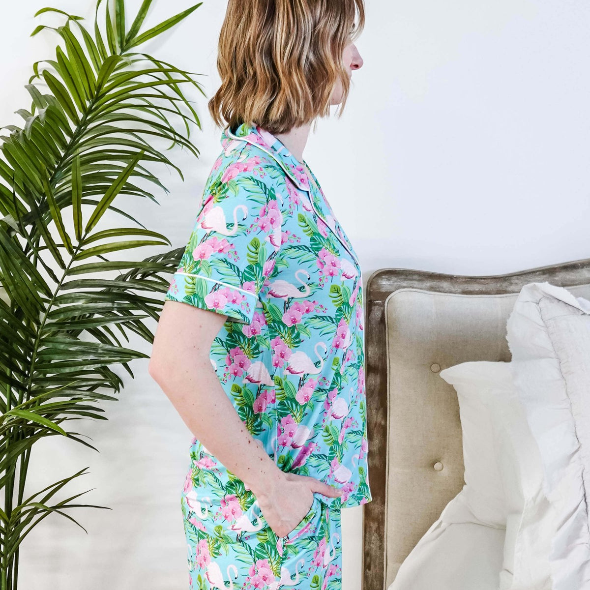 Side view of a model in Tropic Like It's Hot Bamboo Short Sleeve Pajama Set by Georgia Rylan with a tropical print.