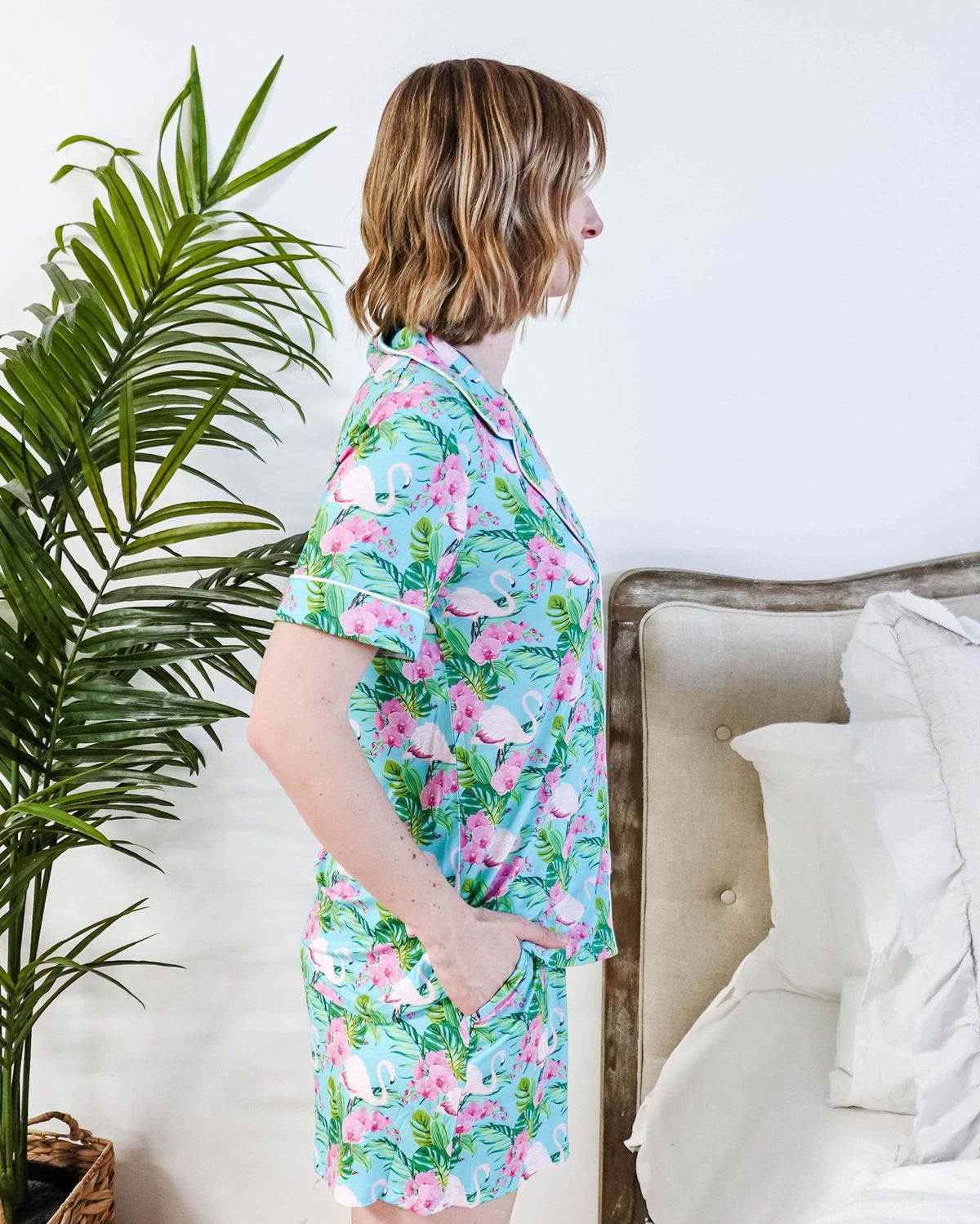 Side view of a model in Tropic Like It's Hot Bamboo Short Sleeve Pajama Set by Georgia Rylan with a tropical print.